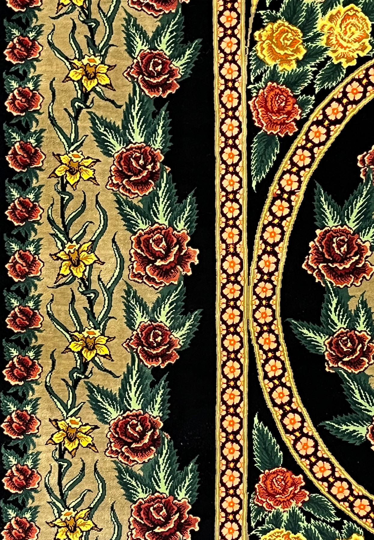 Side border detail of a signed Persian Qum silk rug showing continuous rose patterns, elegant vine movement, and clean transitions between field and border