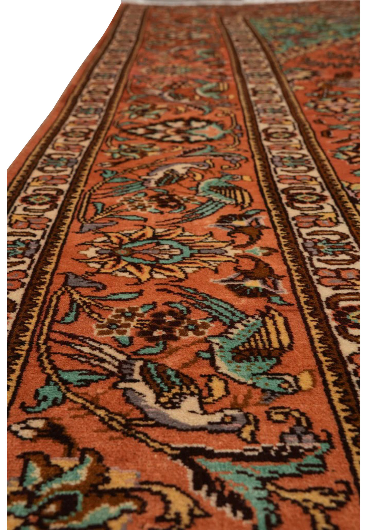 Border close-up of a signed Paradies Persian Tabriz rug with floral vines, ivory detailing, and turquoise accents on terracotta ground