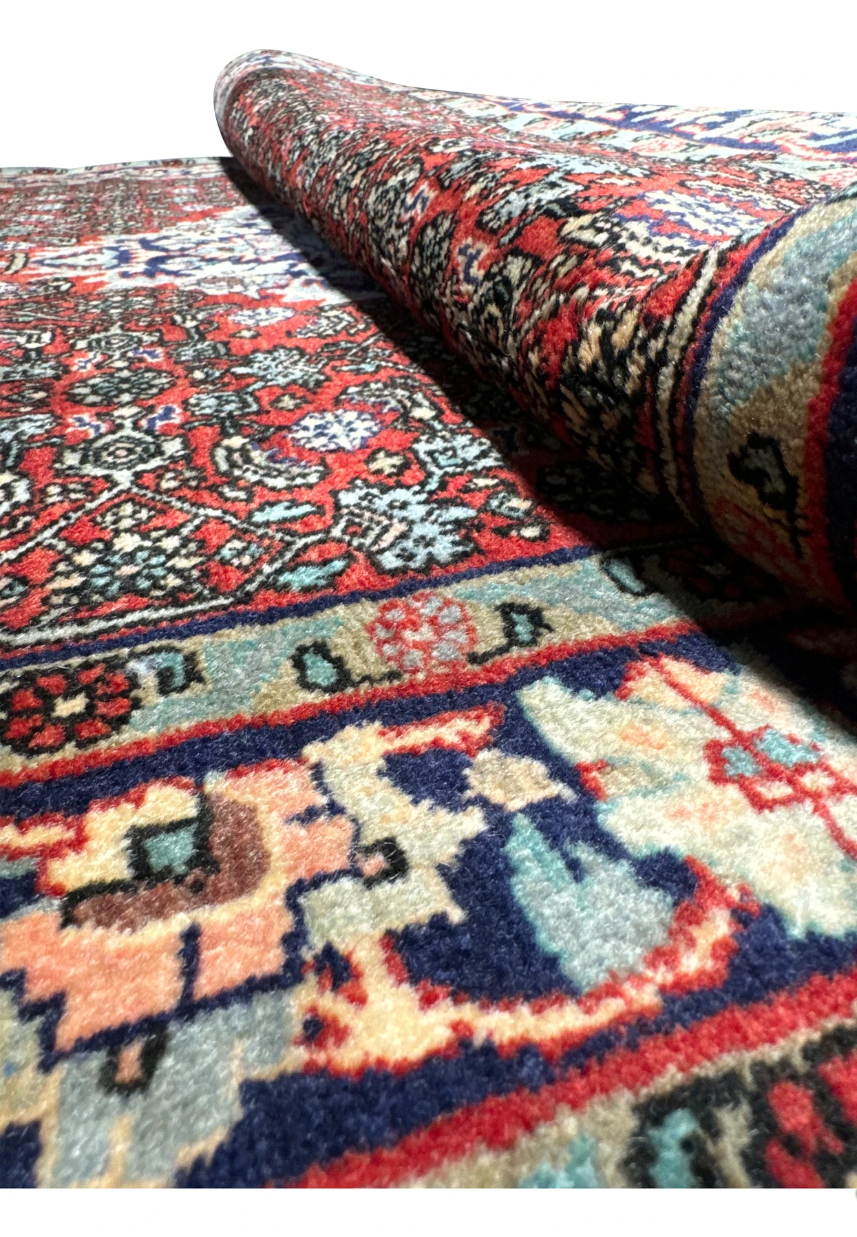 Rolled view of a Persian Sarough rug showing wool pile thickness, dense knotting, and flexible handwoven structure