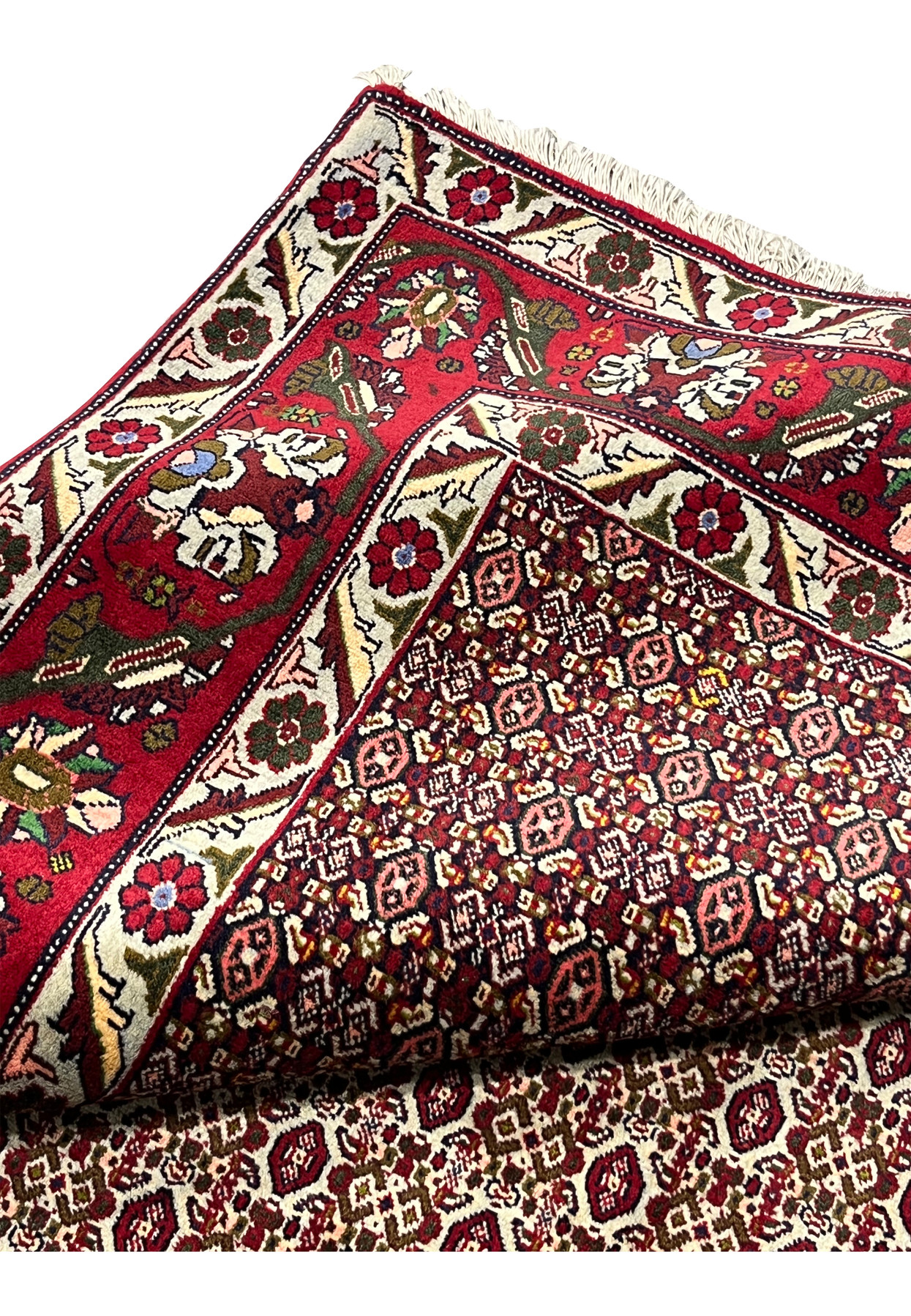 Folded edge view of Persian Senneh rug displaying pile thickness, border alignment, refined finishing, and consistent weave density
