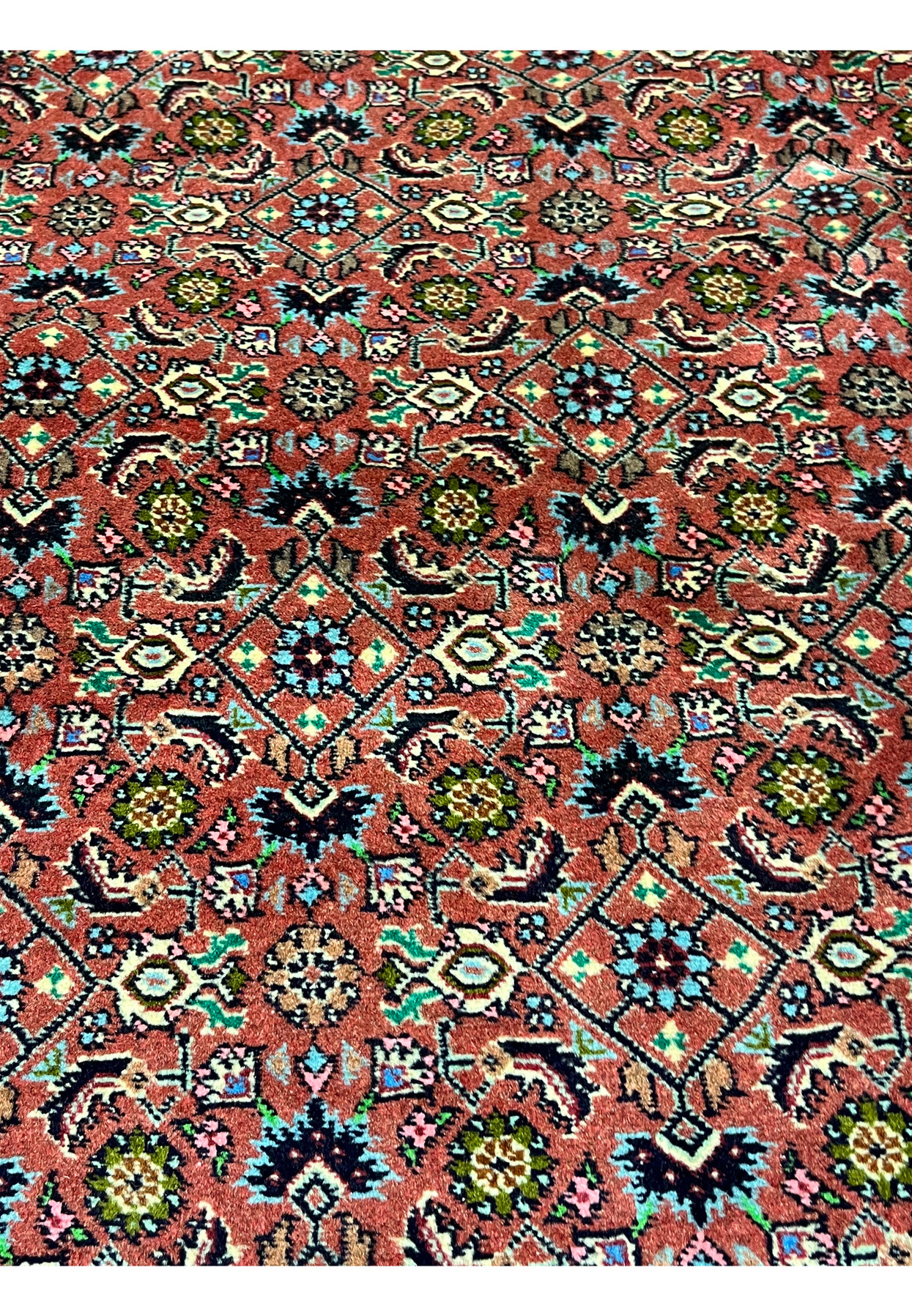 Close-up of Persian Bijar rug motifs featuring stylized flowers, diamond shapes, and classic craftsmanship