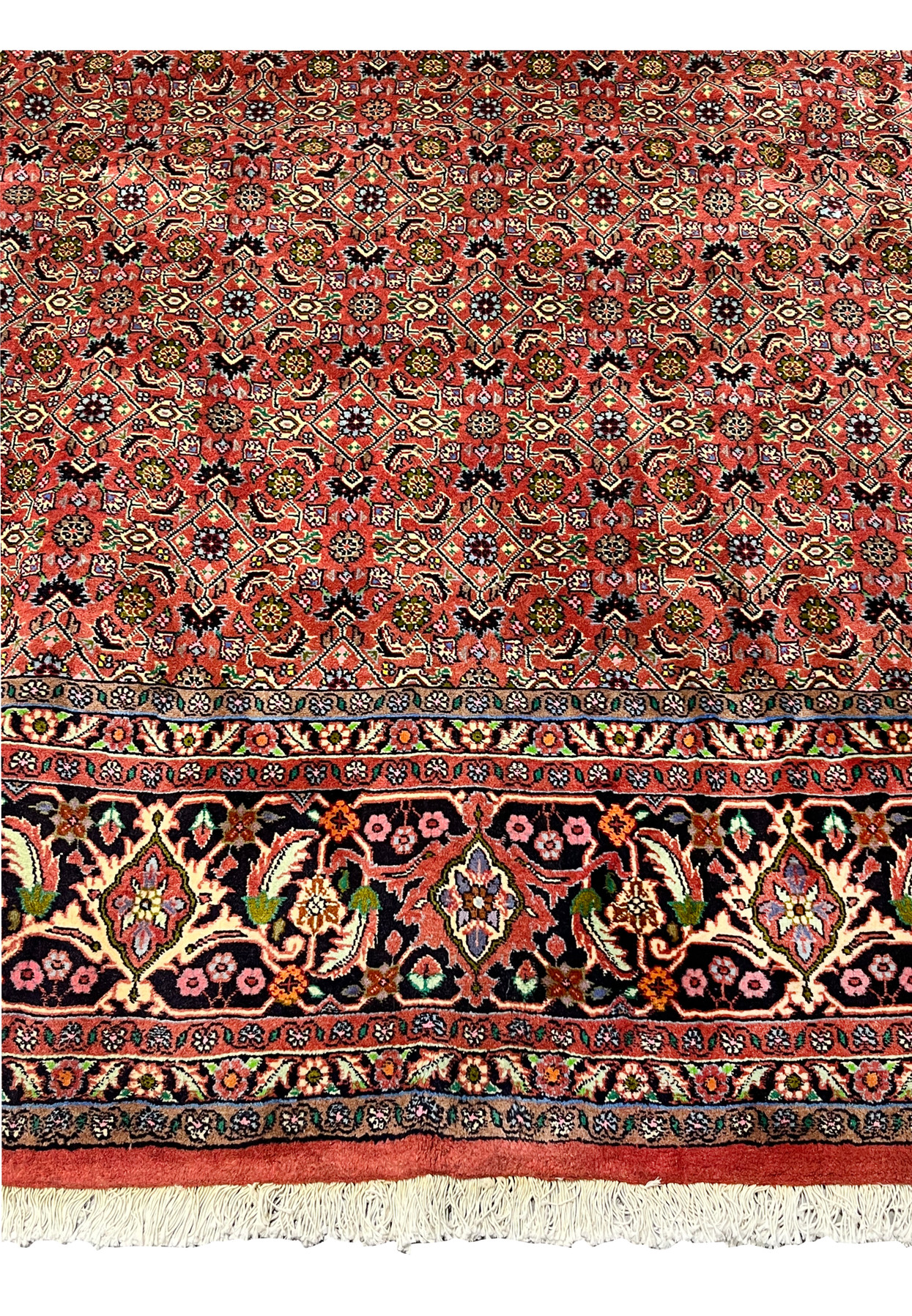 Lower border detail of Persian Bijar rug featuring floral vines, palmettes, and rich navy blue ground