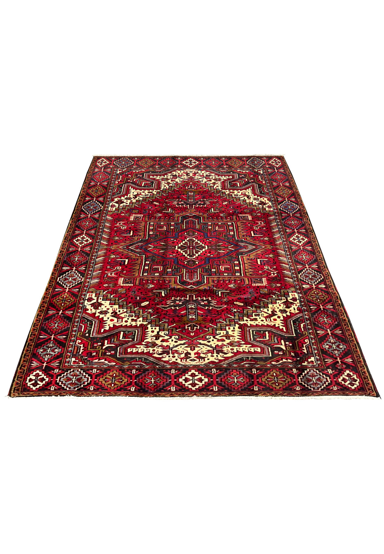 Top view of Persian Heriz area rug showing geometric medallion stepped motifs dense tribal field and classic border proportions