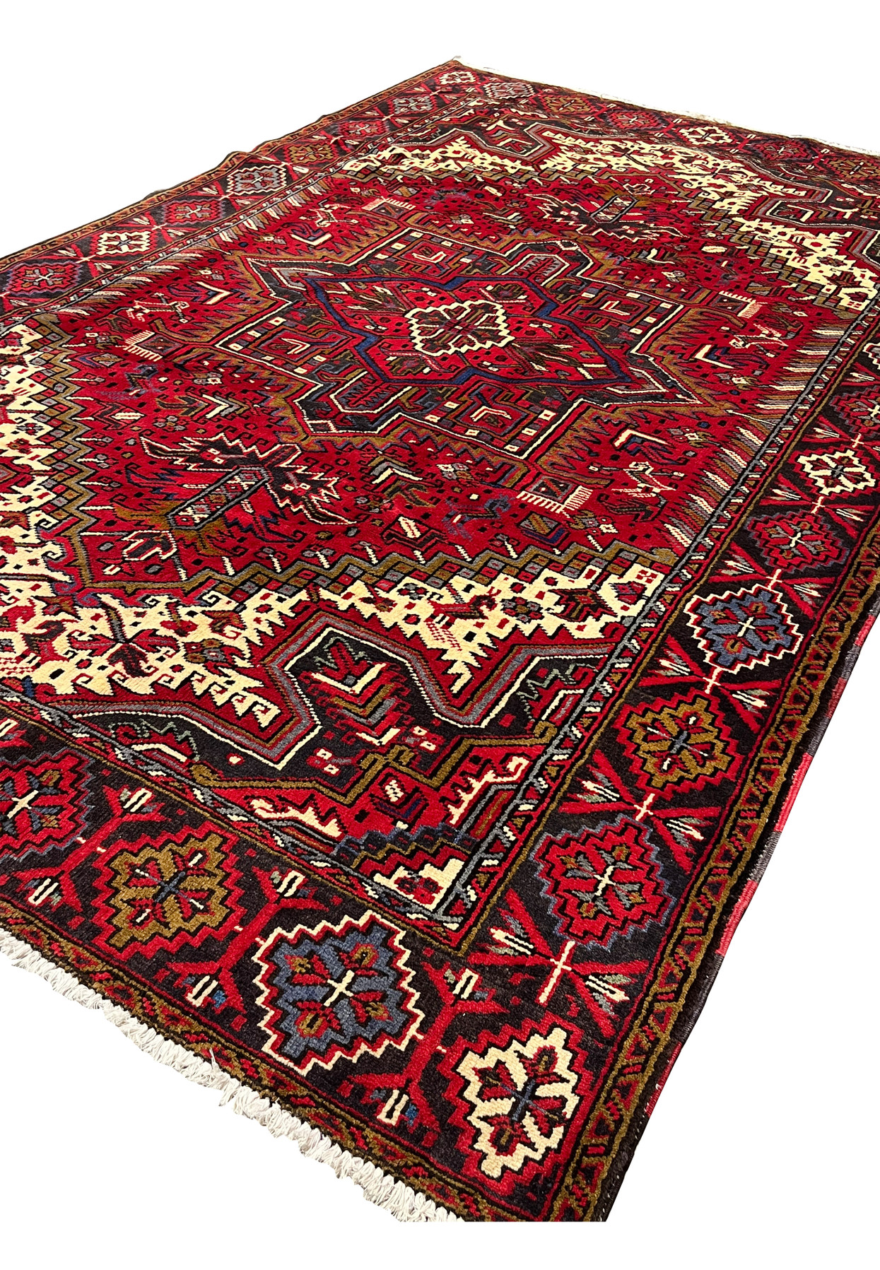 Angled perspective of Persian Heriz area rug revealing pile height texture depth and dimensional tribal geometry across the surface