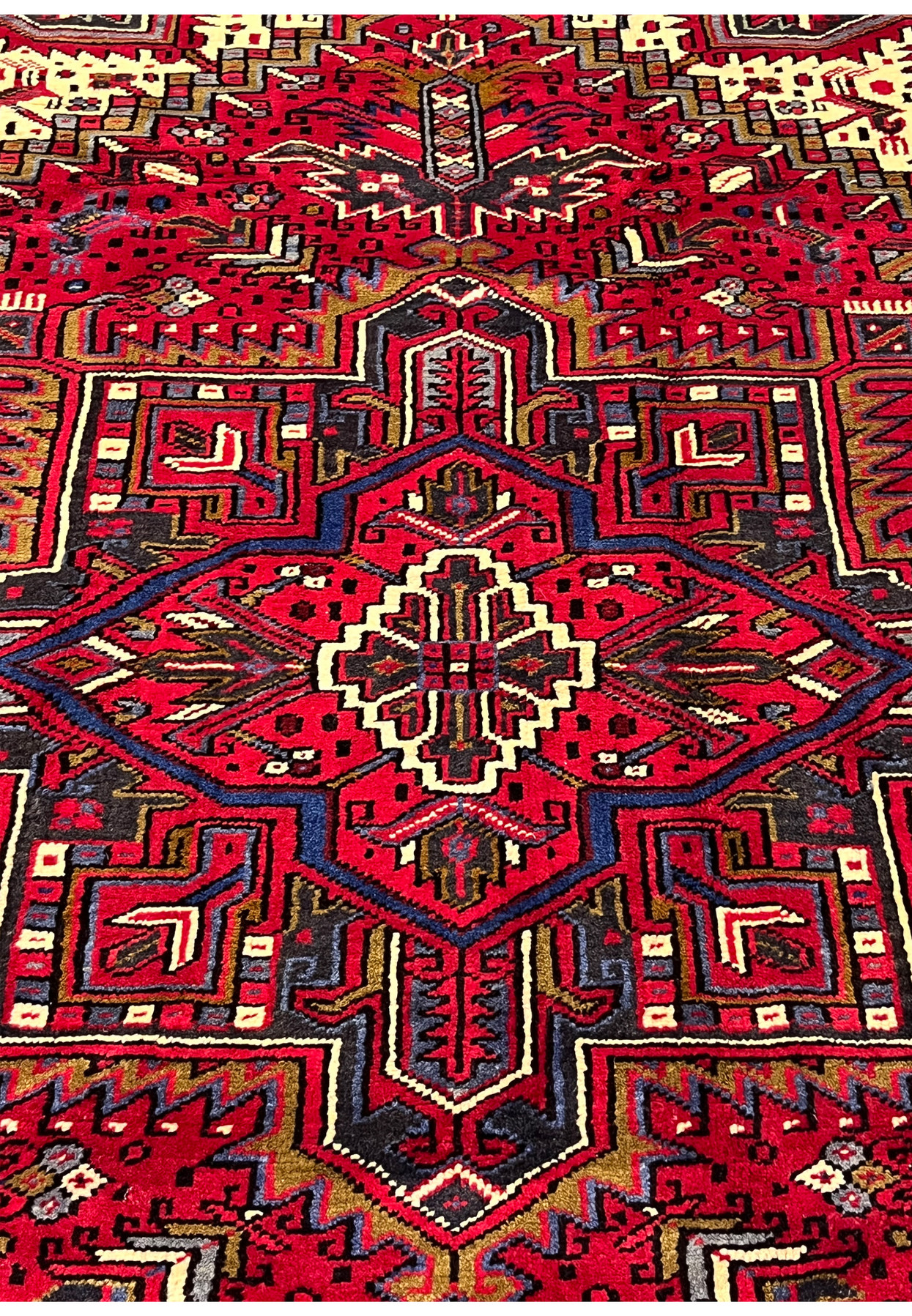 Closeup of Heriz medallion showing crisp outlines tight weave texture and bold angular tribal design craftsmanship in wool pile