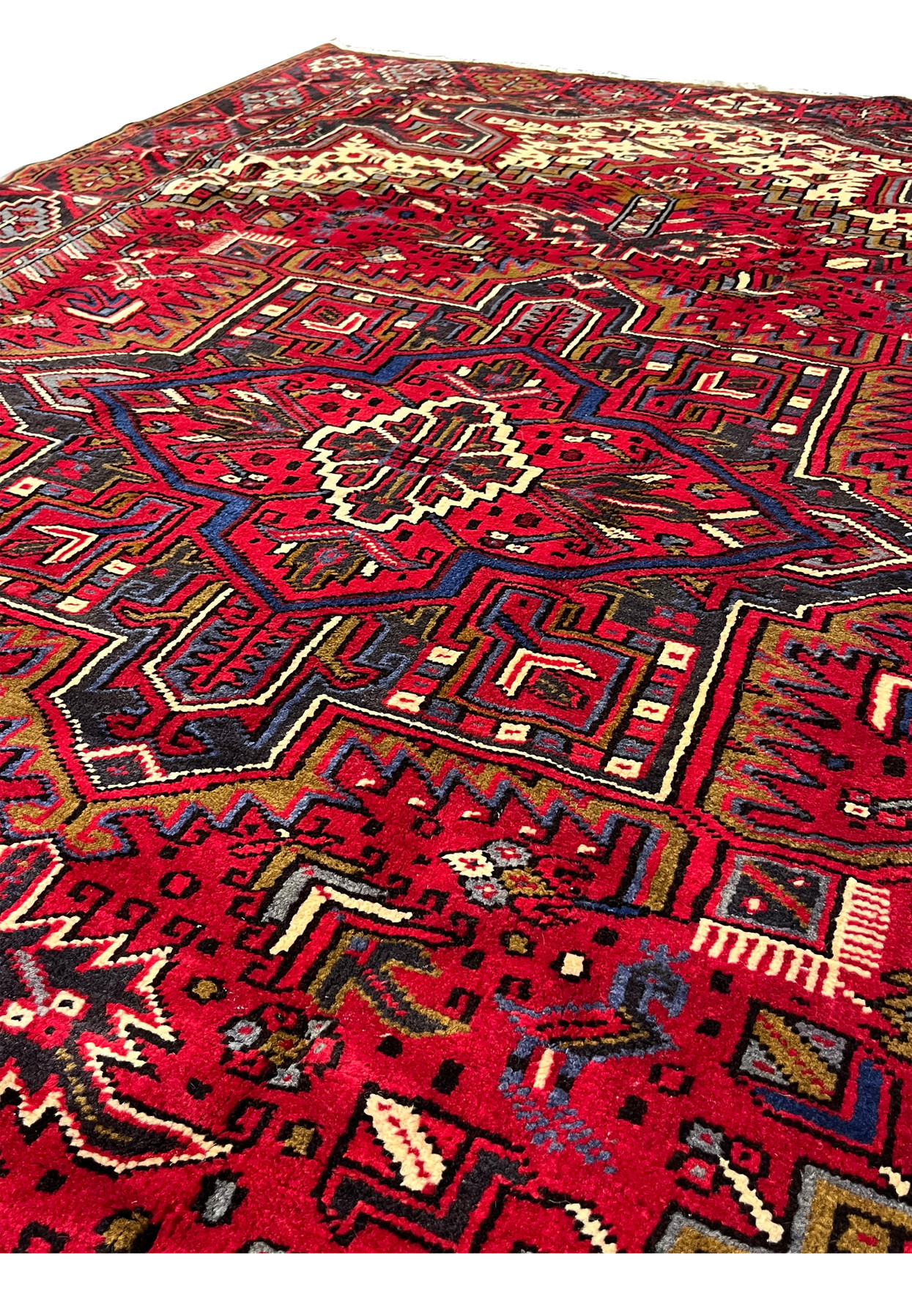 Close view of Persian Heriz rug surface and foundation revealing compact knots, sturdy weave, geometric tribal pattern and rich wool craftsmanship detail