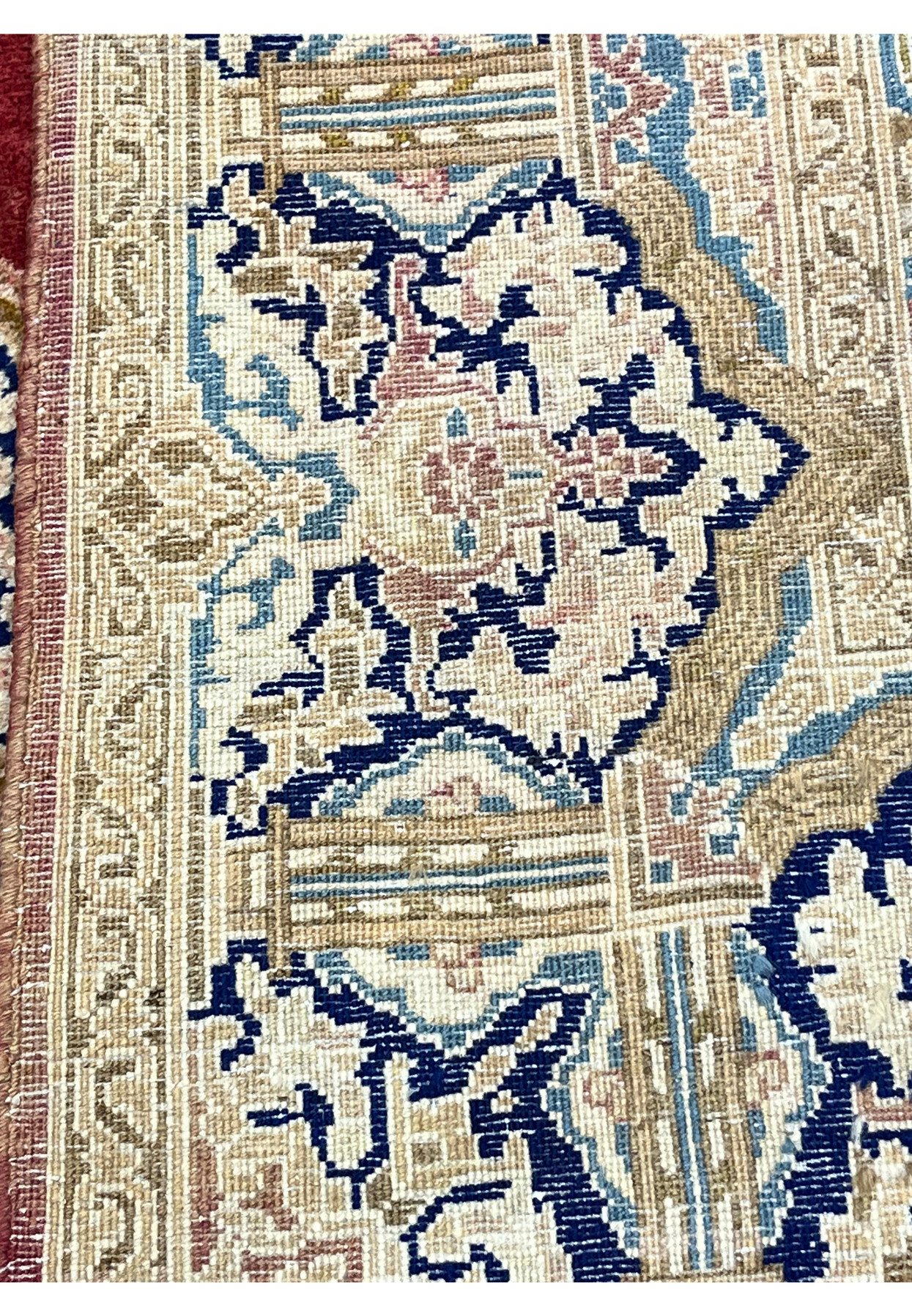 Backside of Persian Kerman rug displaying tight symmetrical knots and clear pattern definition through foundation