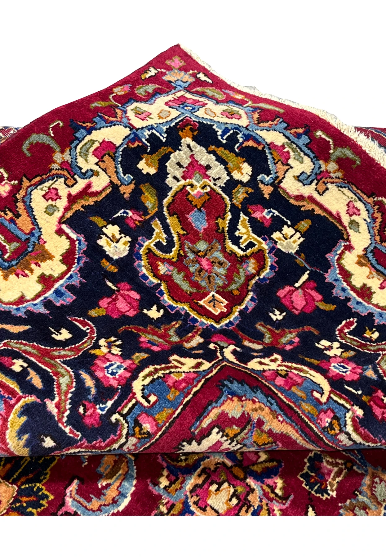 Folded edge view of Persian Mashad rug highlighting clean edge finishing, dense knotting, and vibrant color transitions