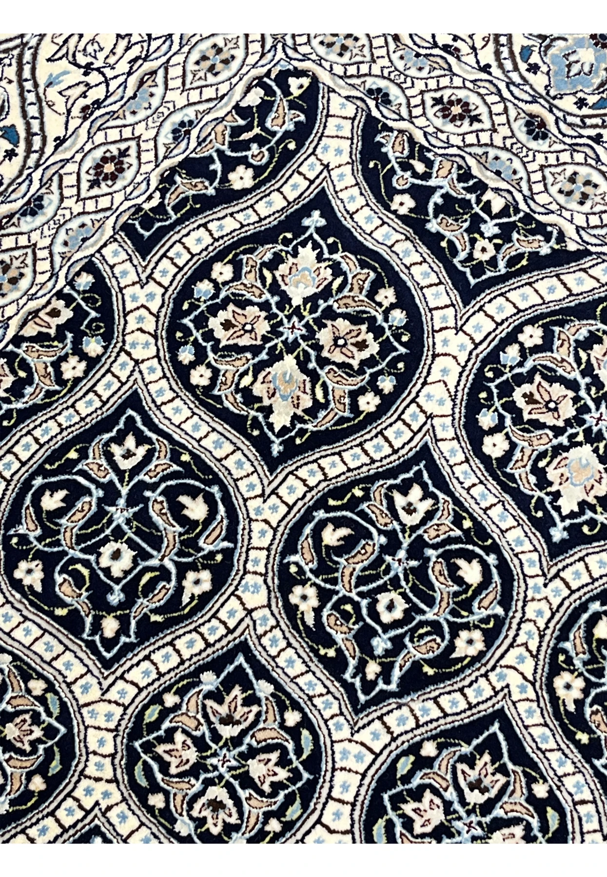 Detailed Gombadi dome pattern on Persian Nain Habibian rug featuring navy cartouches ivory lattice and silk highlights.