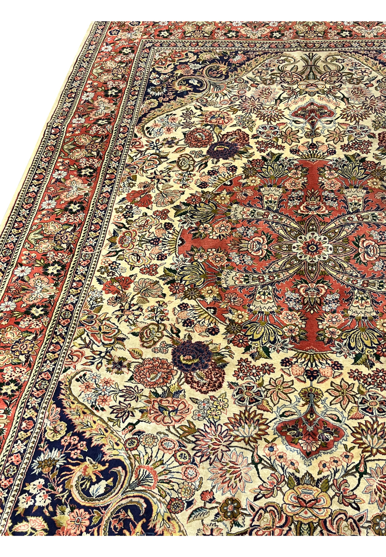 Side angle of premium Persian Bijar rug showing dense pile compact structure and rich coral and navy color contrast