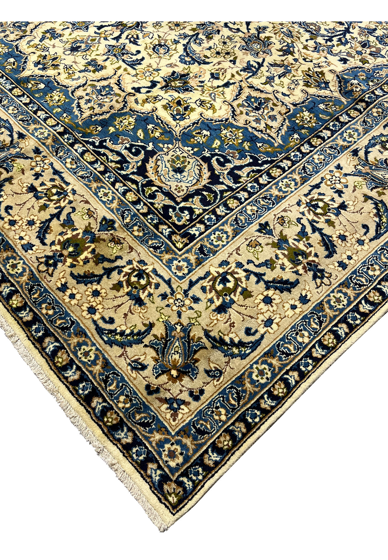 Edge detail of handmade Persian Kashan rug showing navy guard borders ivory field tight wool pile and finished fringe