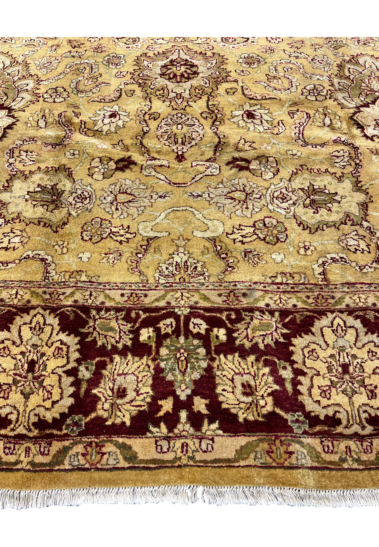 Lower border detail of 9x12 gold Agra rug showing burgundy floral border and ivory guard stripes.