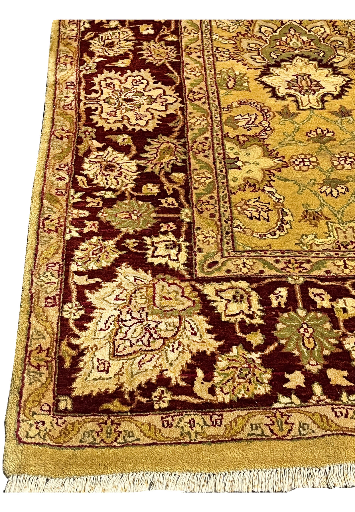 Rich burgundy main border detail with large ivory floral blossoms and olive vine work framing the gold field Agra rug.