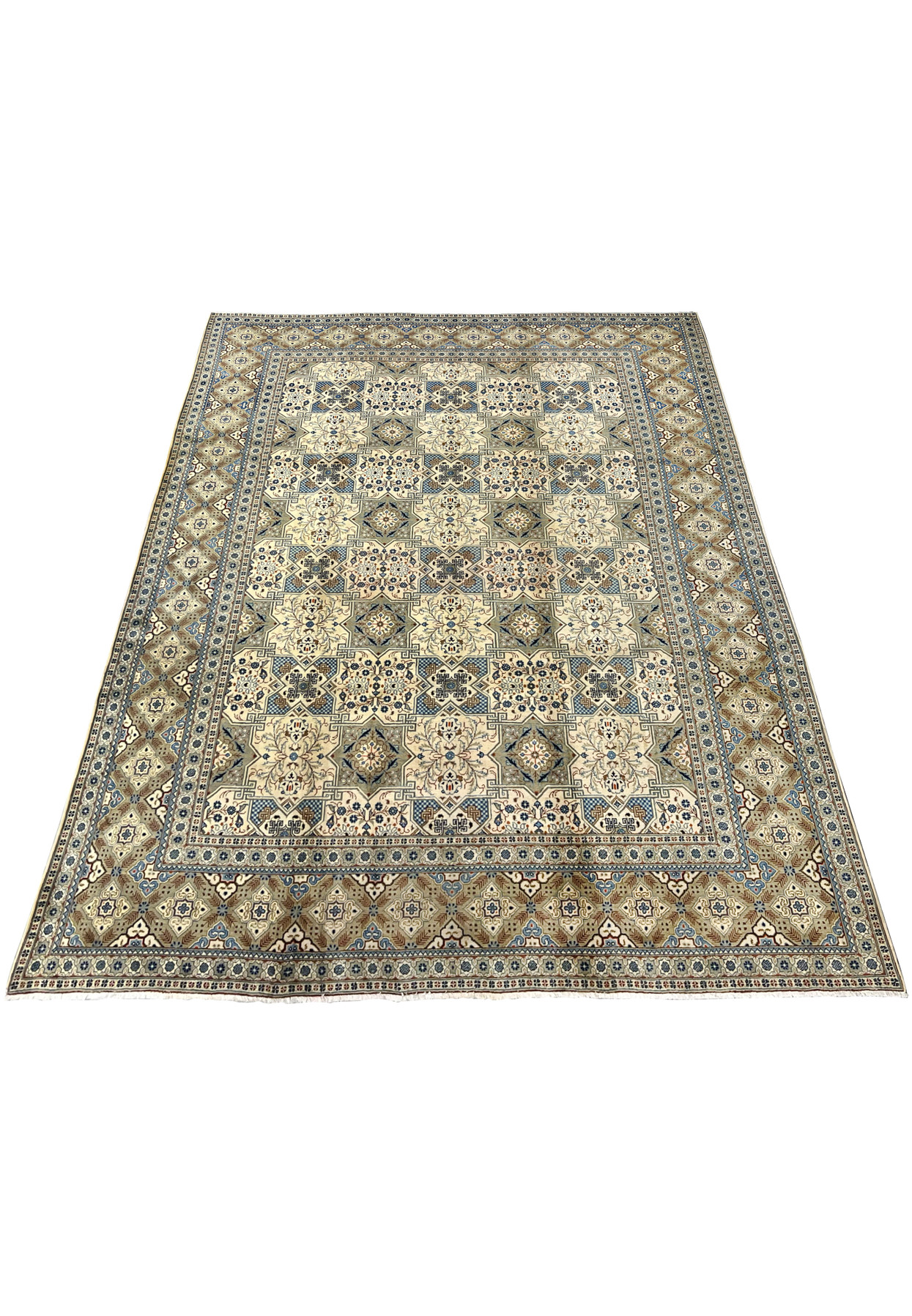 Perspective view of a large hand-knotted Tabriz rug laid flat on a white surface, showcasing the full proportions of the 9’8 x 13 carpet with its all-over panel design, multi-band border, and short cotton fringe at both ends.