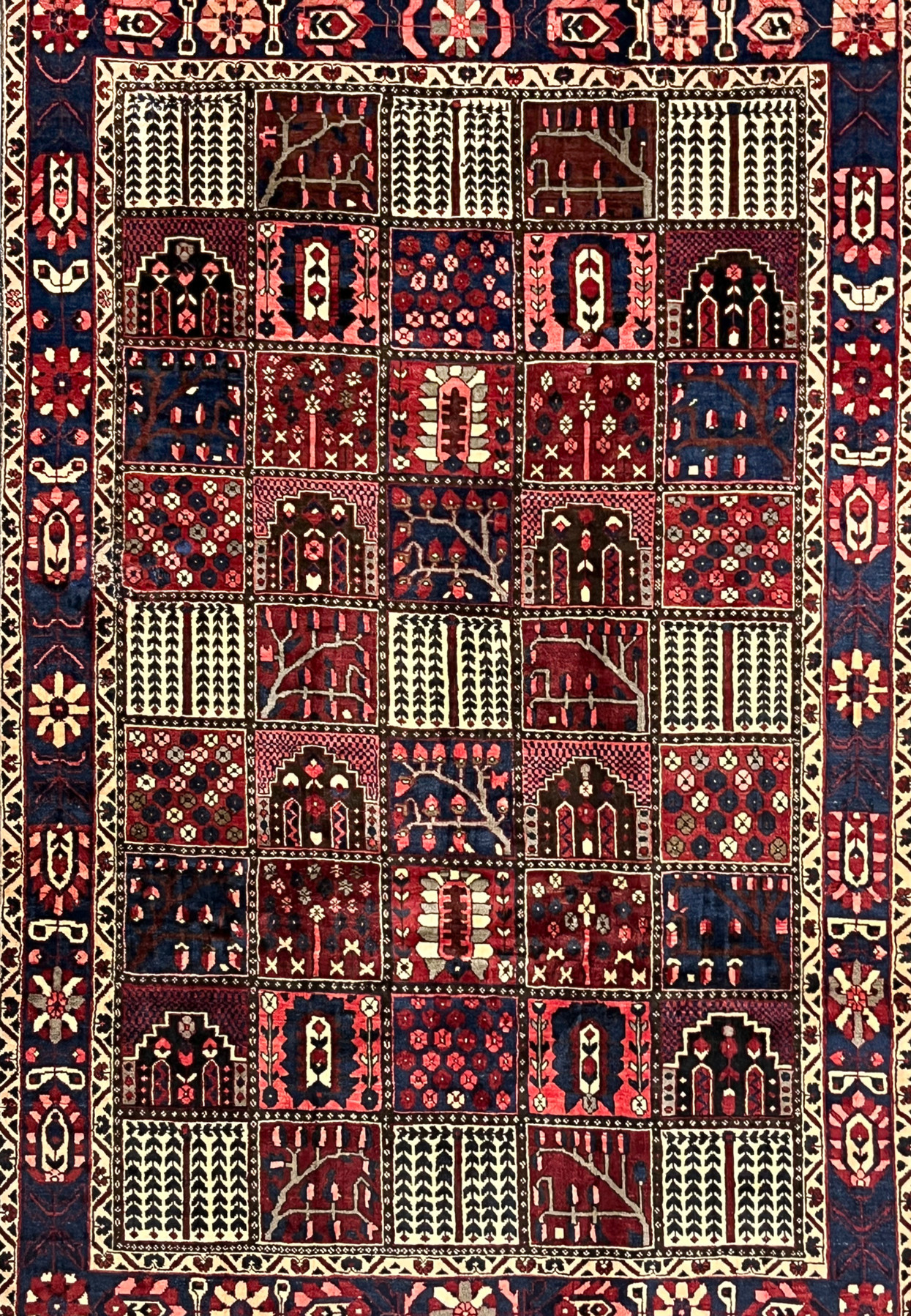 Midfield garden panels of 7x10 hand-knotted Persian Bakhtiari rug with cypress and floral compartments