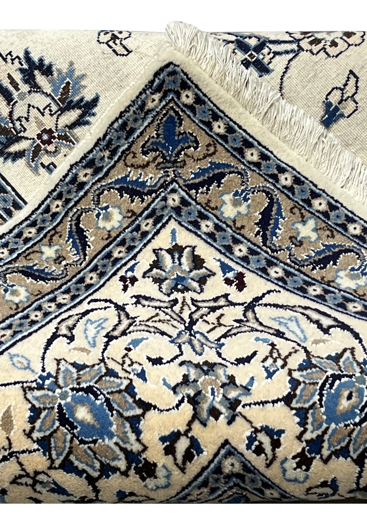 Folded corner of 8x11 Persian Nain 9La rug revealing pile height, silk highlights, and weave structure