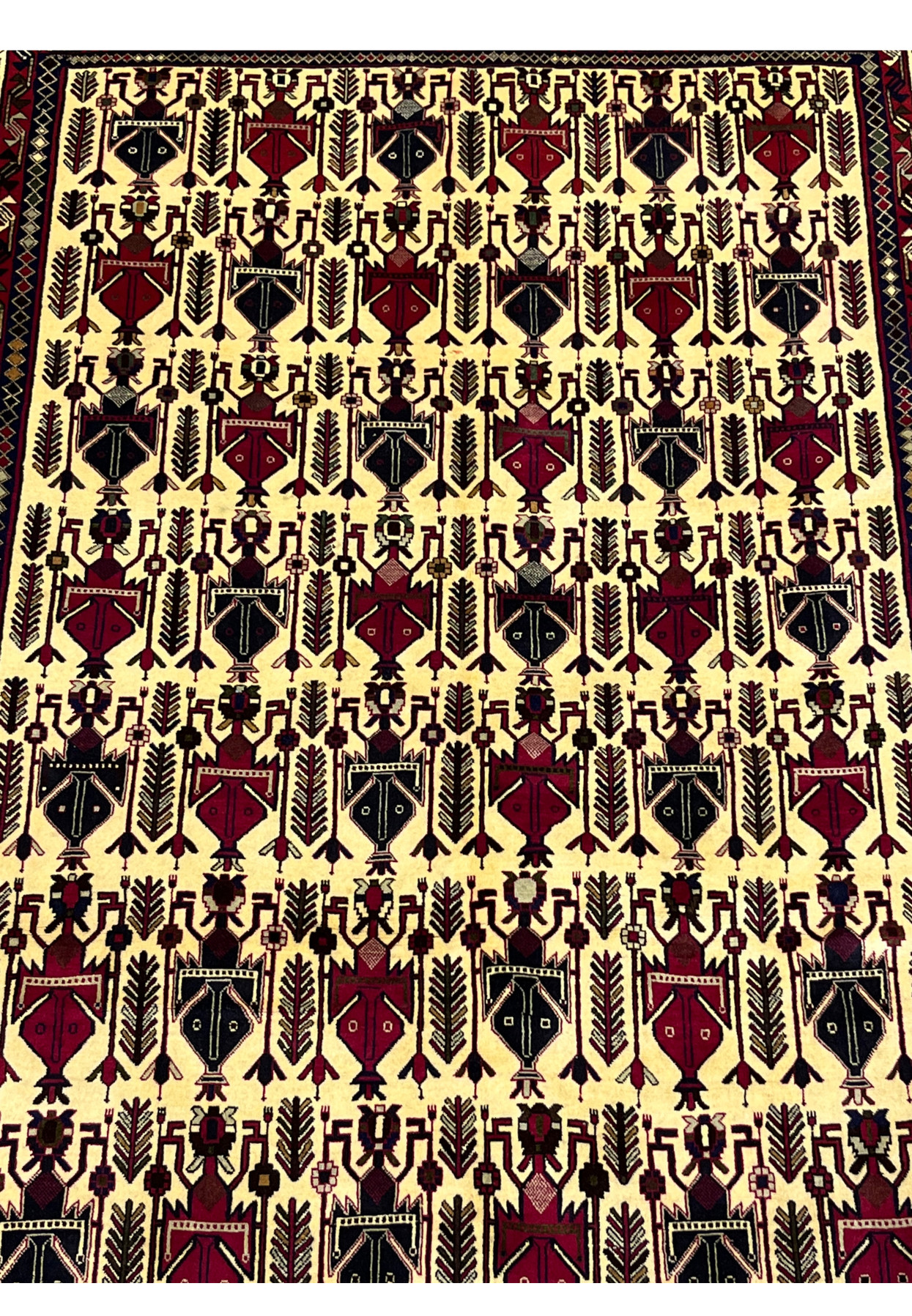 Midfield detail of 5x8 Persian Afshar rug showing allover boteh and vase motifs on ivory ground