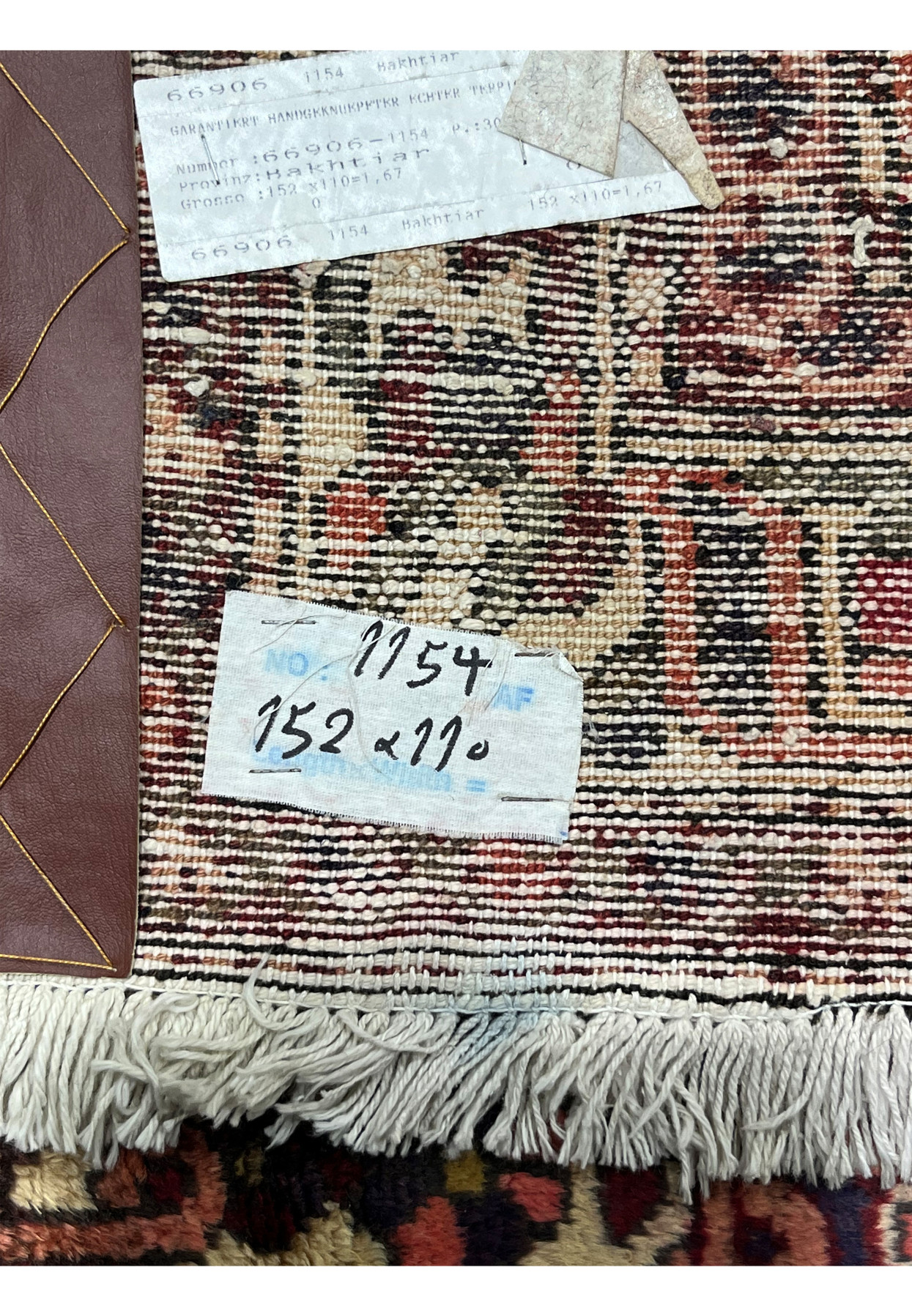 Back of antique 3'7"x5 Persian Bakhtiari rug showing hand-knotted wool construction and age