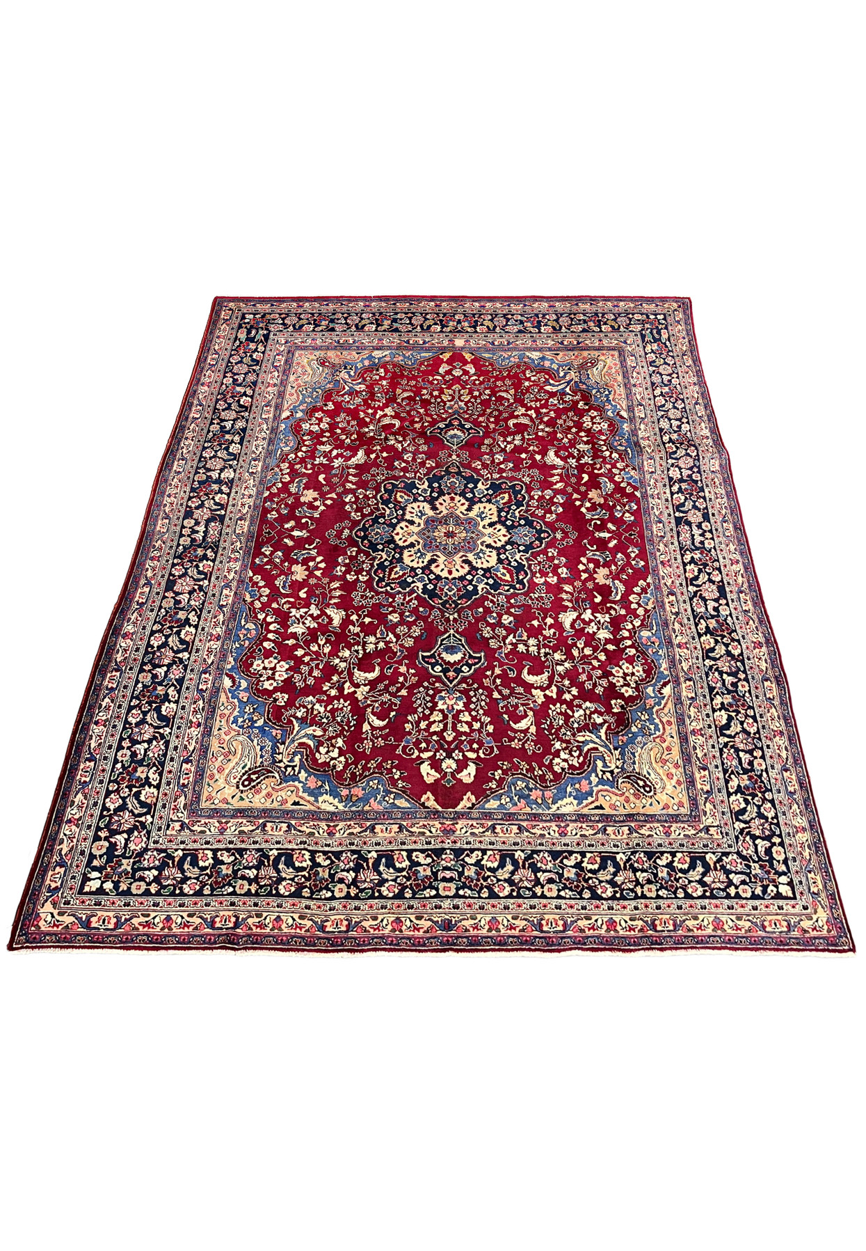 10x13 distressed antique Persian Mashad rug laid flat red field ivory navy border medallion