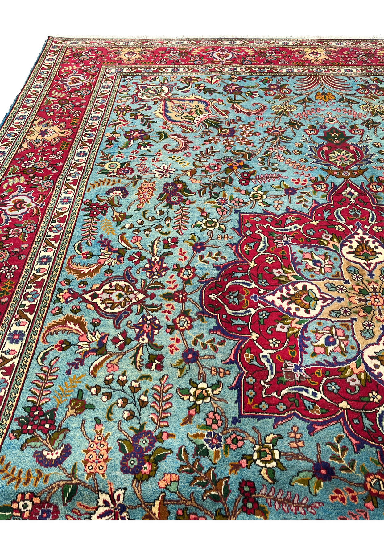 Field view of 10x13 Persian Tabriz rug, sky blue ground with floral bouquets and curling vines
