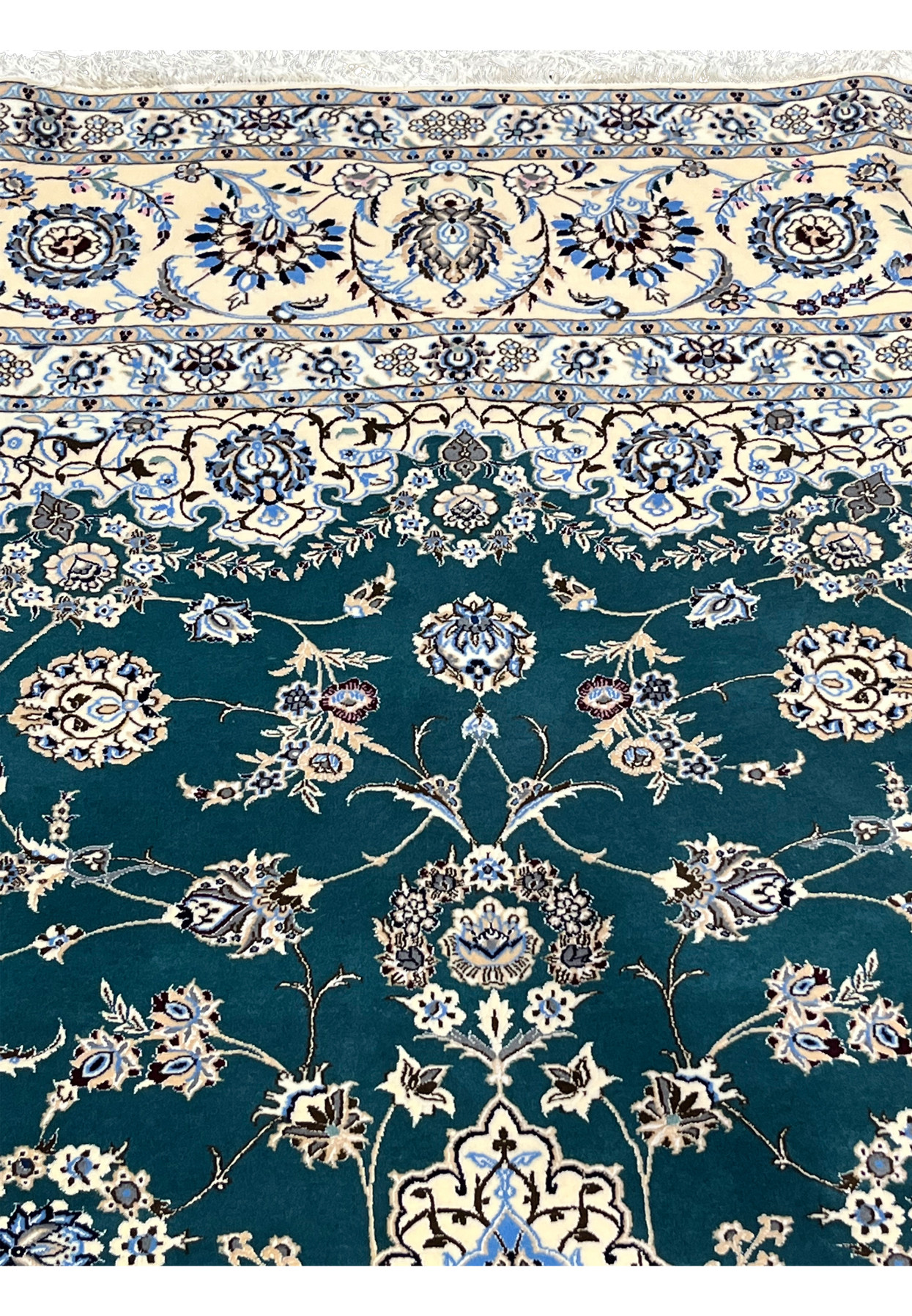 Upper field and border transition showing emerald green ground meeting ivory floral frame