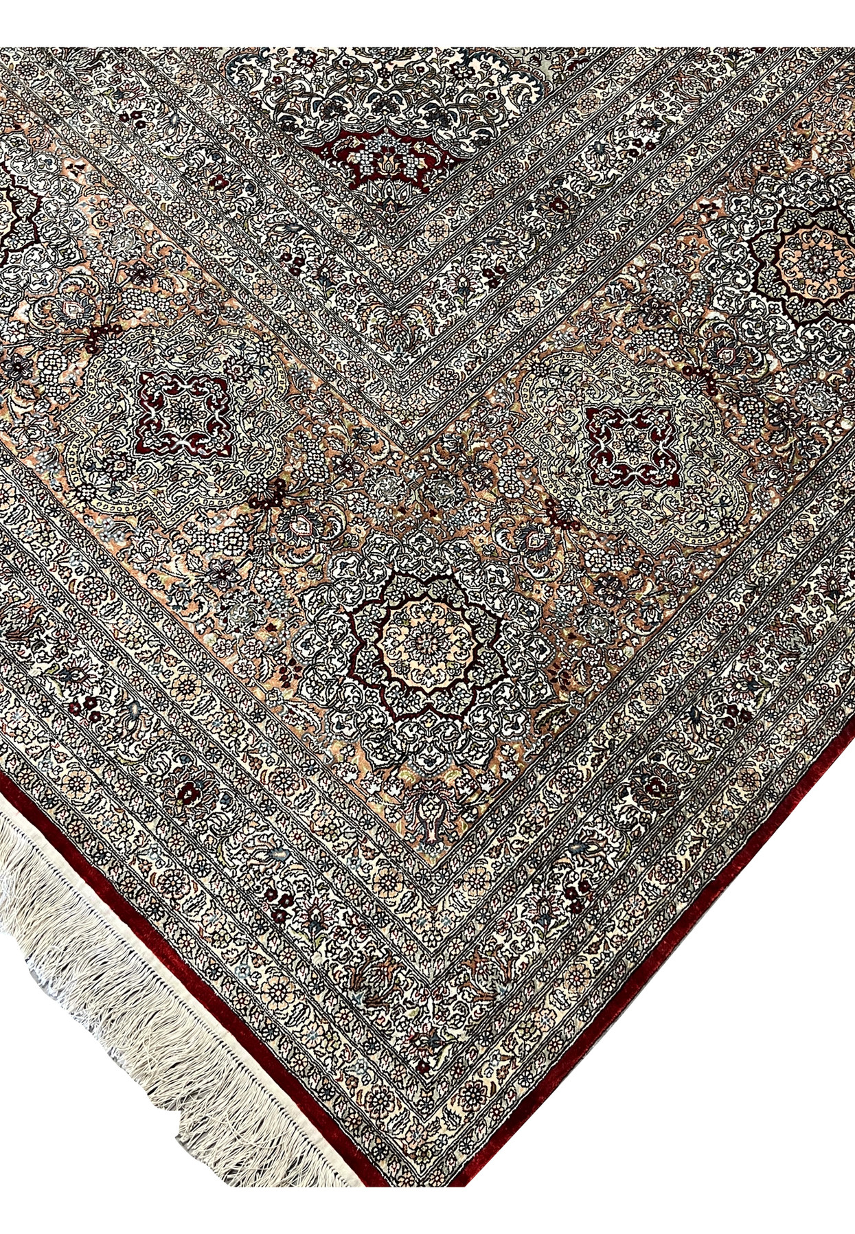 Edge detail of this authentic Turkish silk rug showing deep burgundy selvedge and ivory fringe