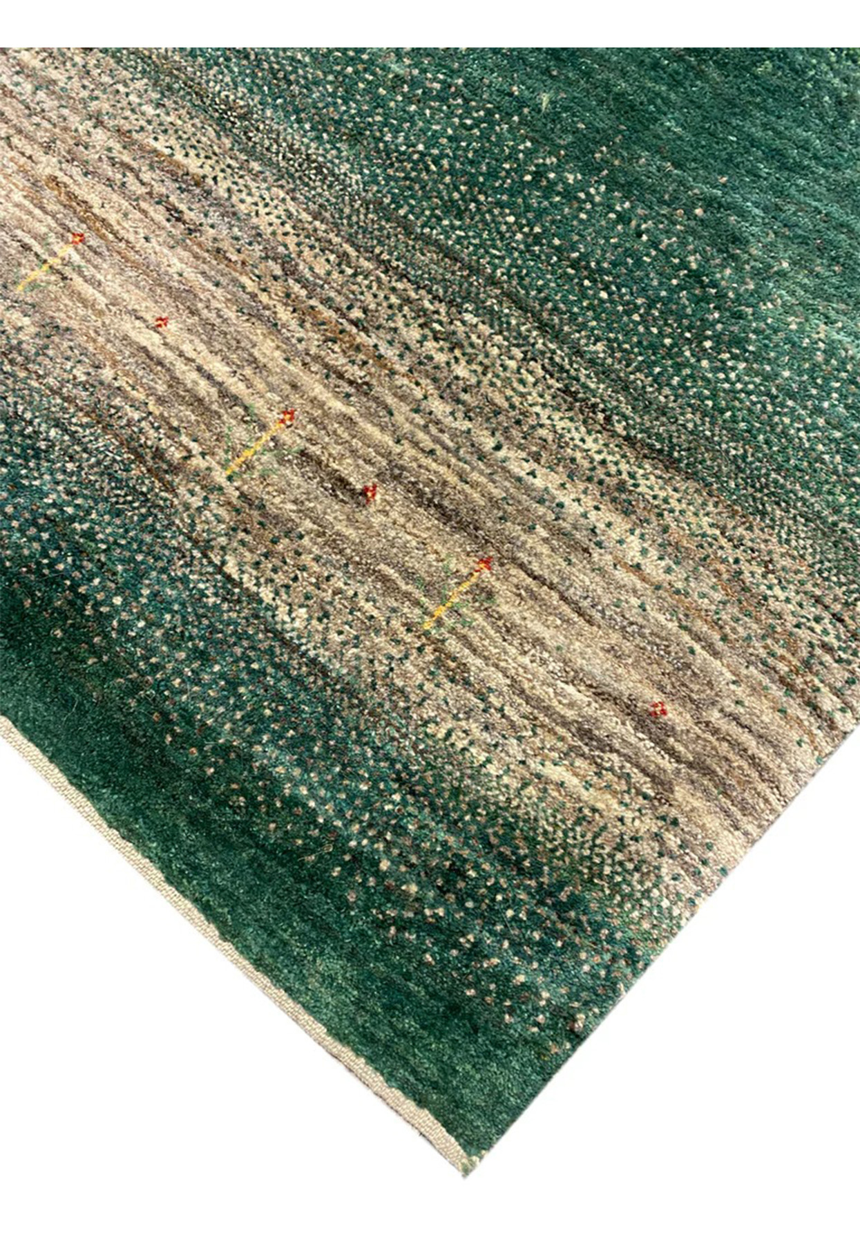 Hand-knotted Indo Gabbeh edge close-up showing emerald pile and clean ivory selvage finishing