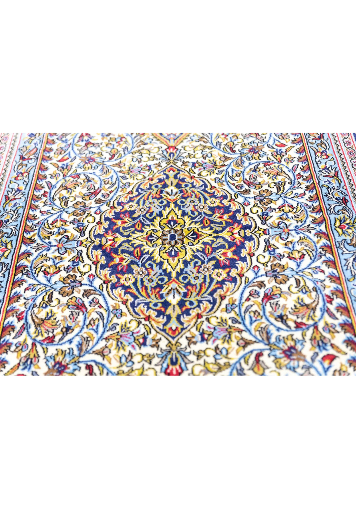Indigo central medallion close-up with golden palmettes and red rosettes on Persian Qum kork wool rug
