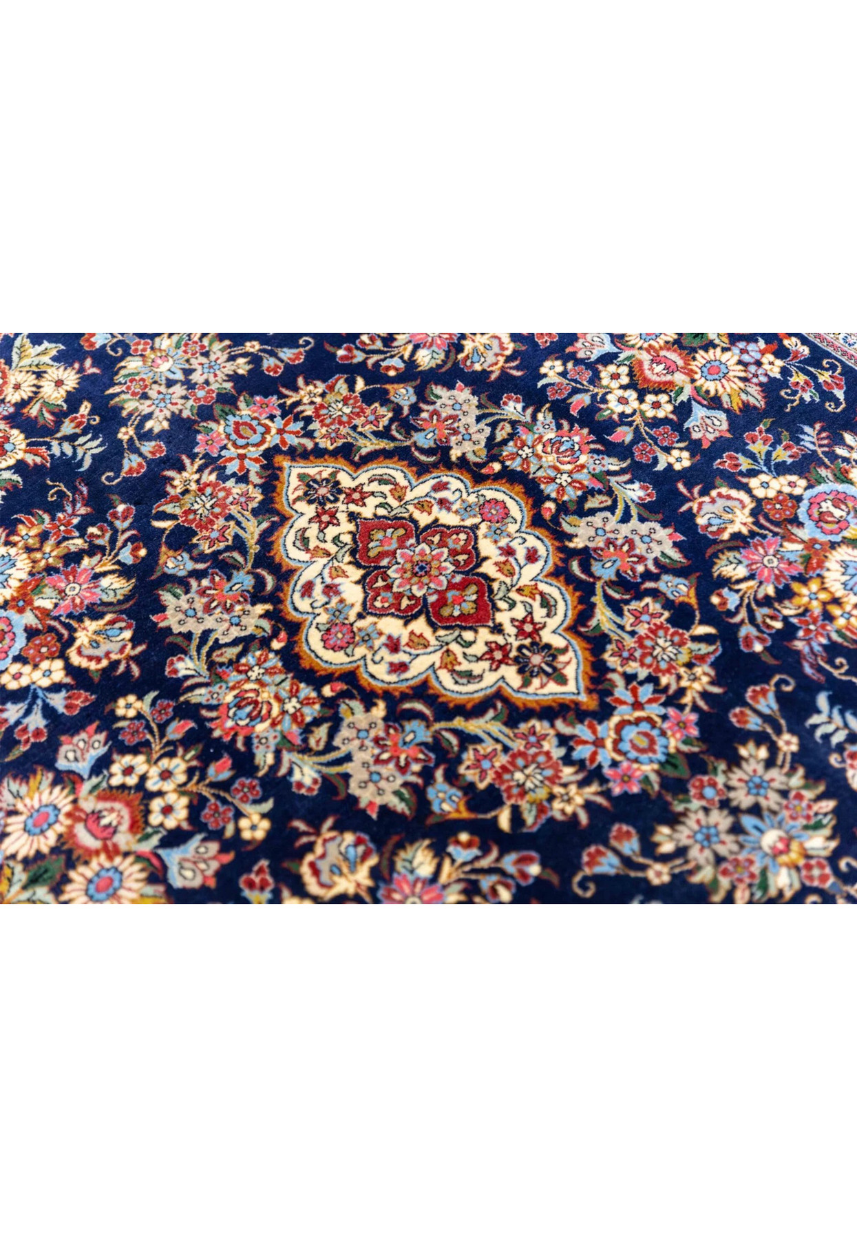 Lobed quatrefoil central medallion close-up of Persian Qum kork rug with miniature pink and gold blossoms