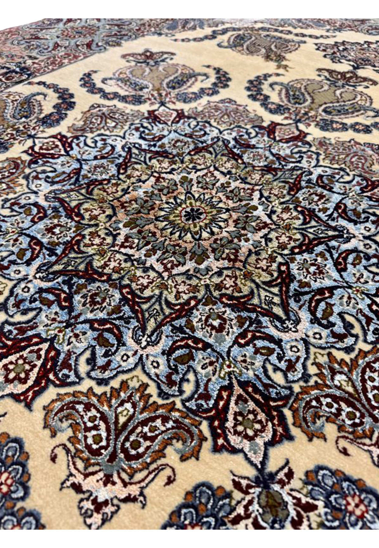 Closeup of intricate snowflake medallion with sky blue, ivory, and burgundy floral detail and silk accents