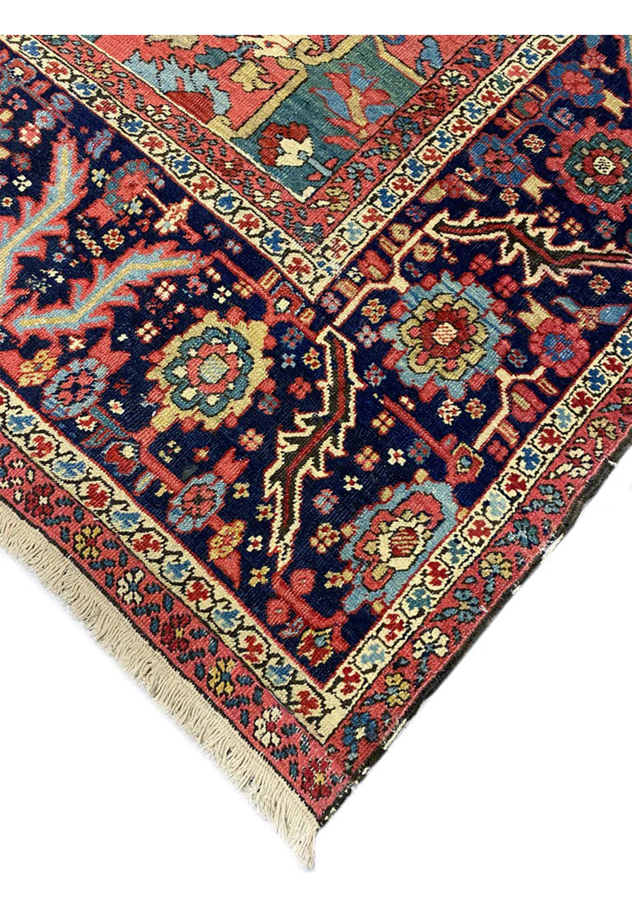 Edge and fringe detail of hand-knotted antique Persian Serapi Heriz rug showing aged ivory cotton fringe