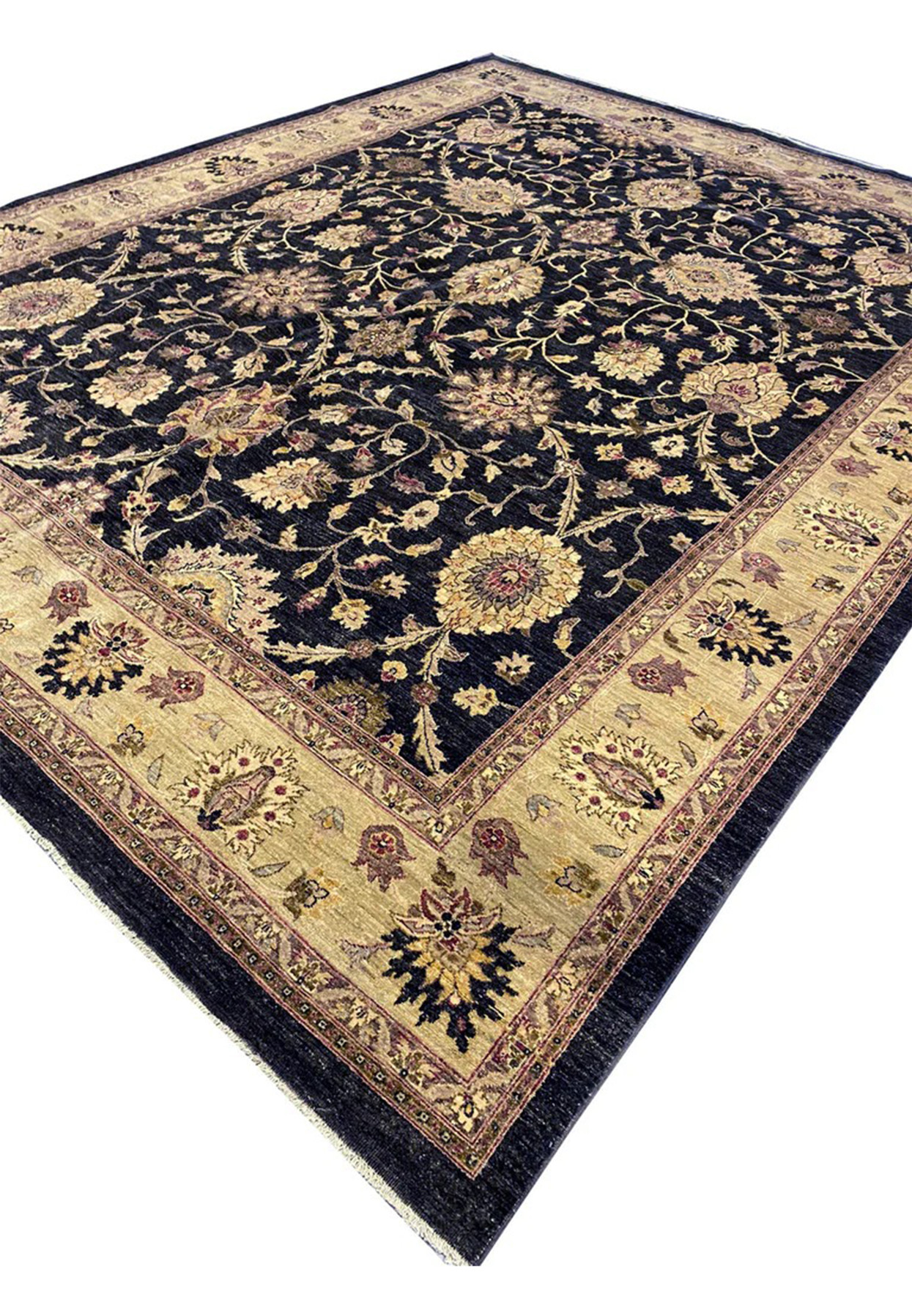Angled view of large 12x15 Oriental Agra rug with deep black field and warm antique gold main border