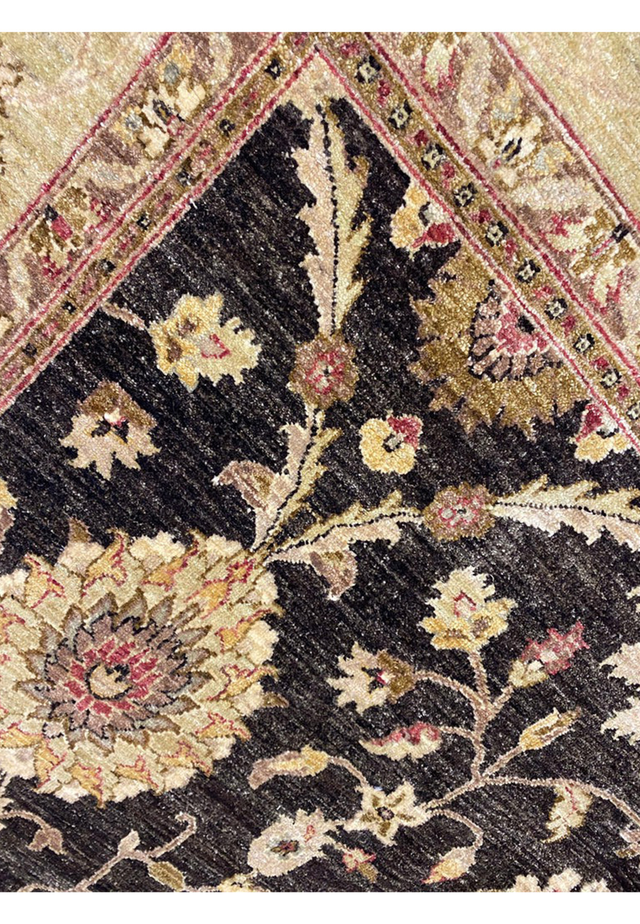 Color closeup showing soft gold, ivory, rose, and pistachio palmette on deep black hand-knotted field
