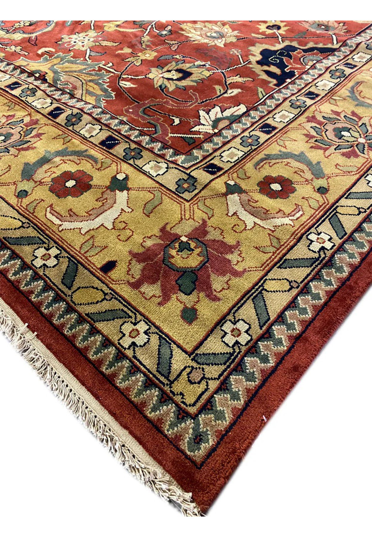 Edge and corner detail of hand-knotted Oriental Agra rug with navy guard stripes on antique gold border