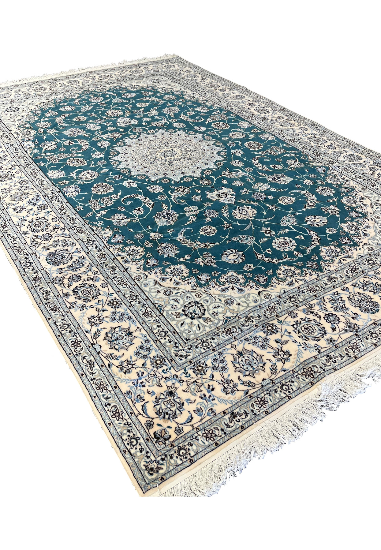 Angled view of master Habibian Nain 6 La rug showing emerald green field and silk highlights