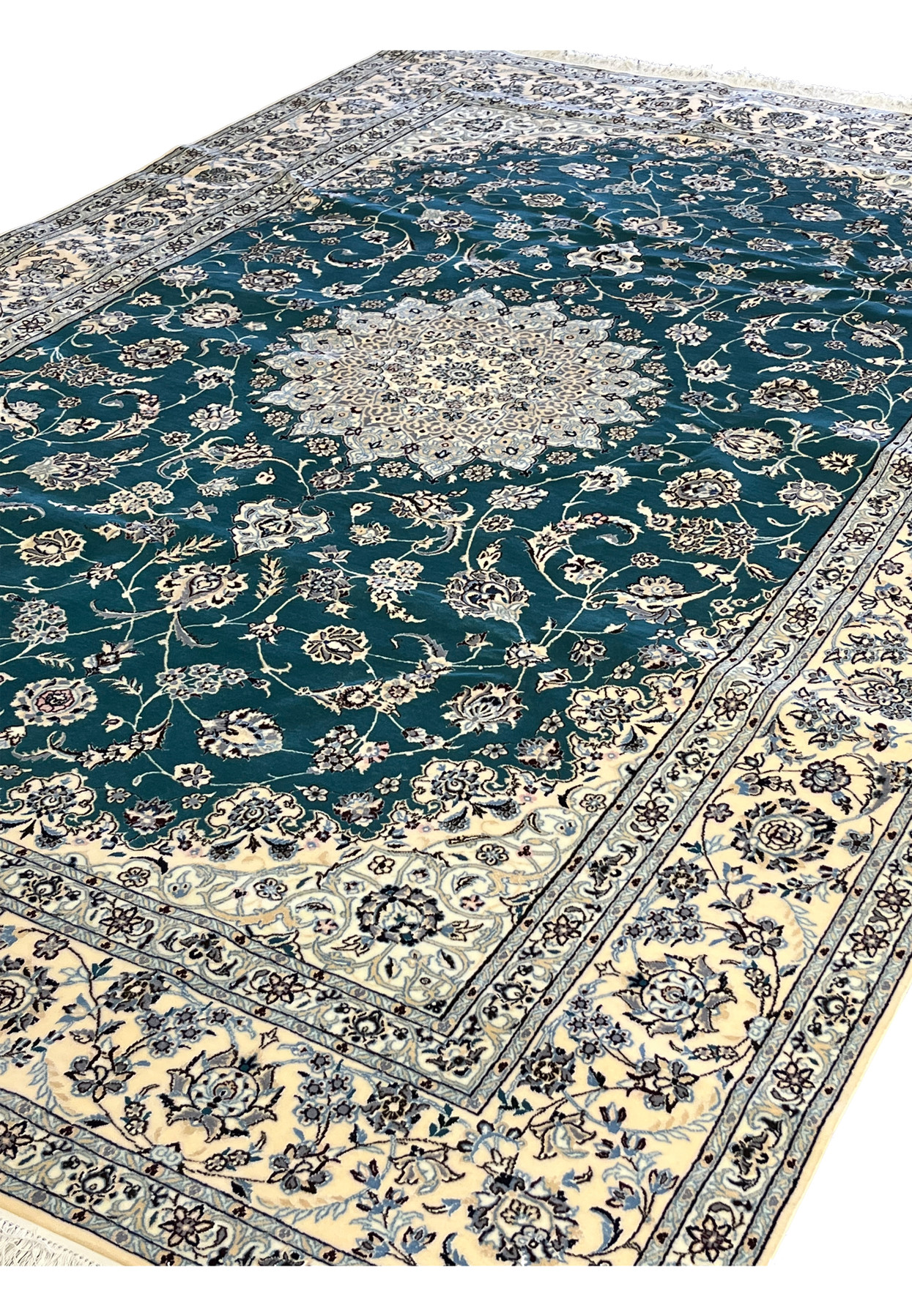 Angled floor view of authentic Persian Nain 6 La rug with ivory border framing emerald green field