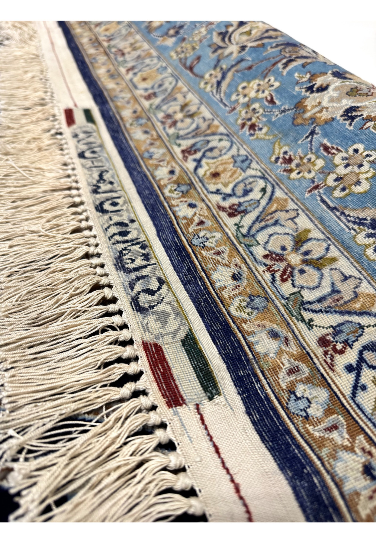Reverse signature view on master-signed Persian Isfahan rug showing Zolfaghari cartouche woven into apron