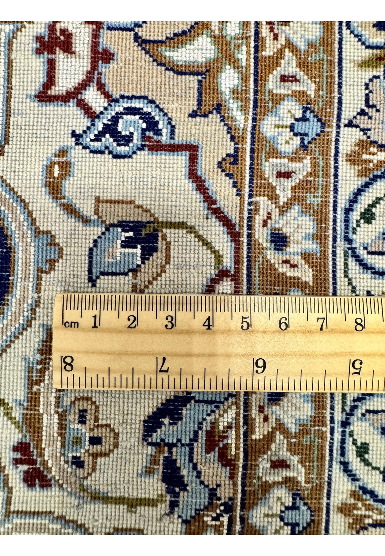Knot density measurement on backside of authentic Zolfaghari Isfahan rug showing approximately 700 KPSI count