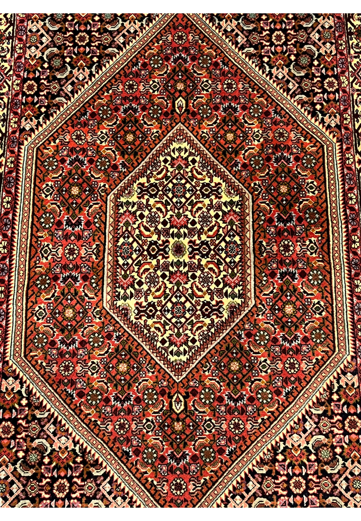 Closeup of the ivory hexagonal medallion at the center showing dense Mahi Herati fish motifs