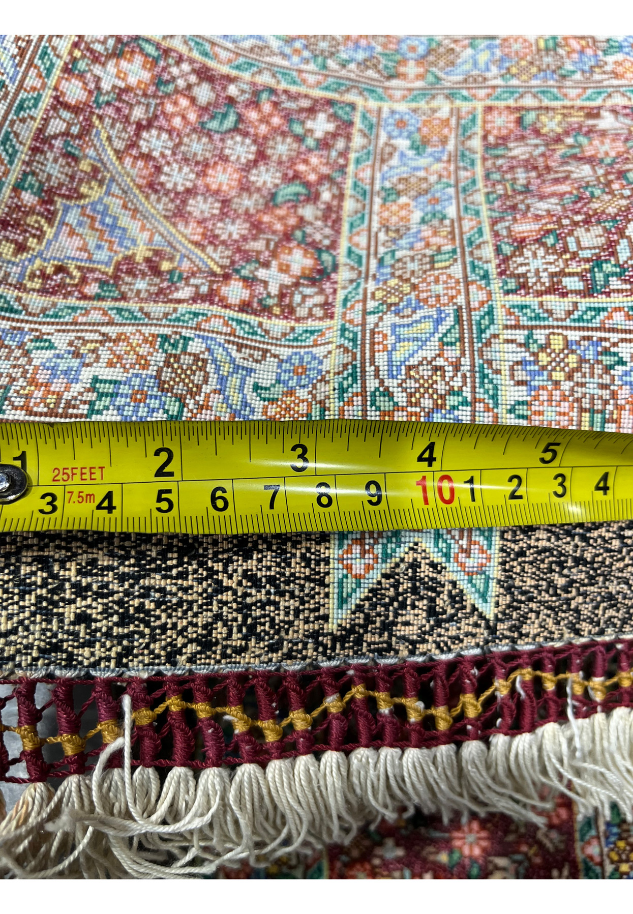 Backside with tape measure documenting the 900 KPSI ultra fine knot density of this Qum