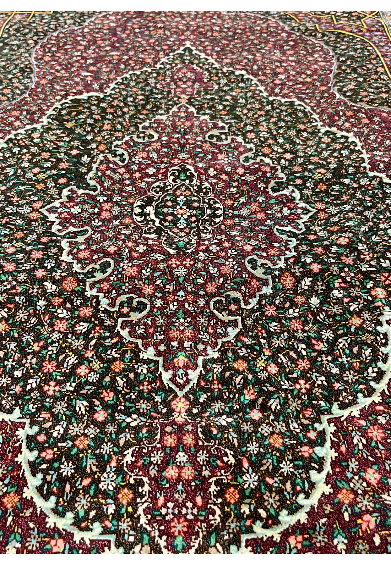 Midfield detail of the pure silk pile showing the painterly density of floral motifs