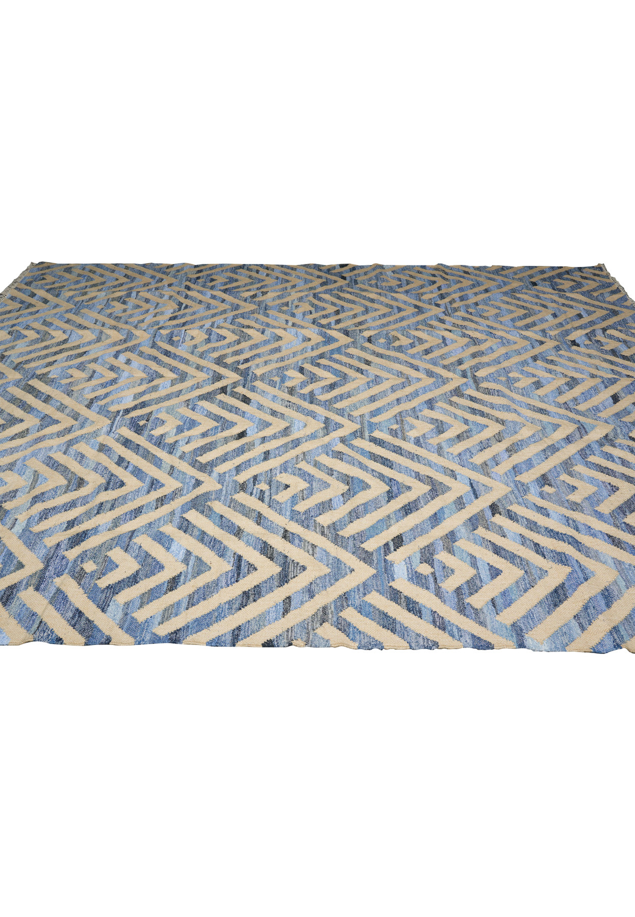 The brand new flatweave laid out fully showing the complete diamond and chevron repeat in blue and cream