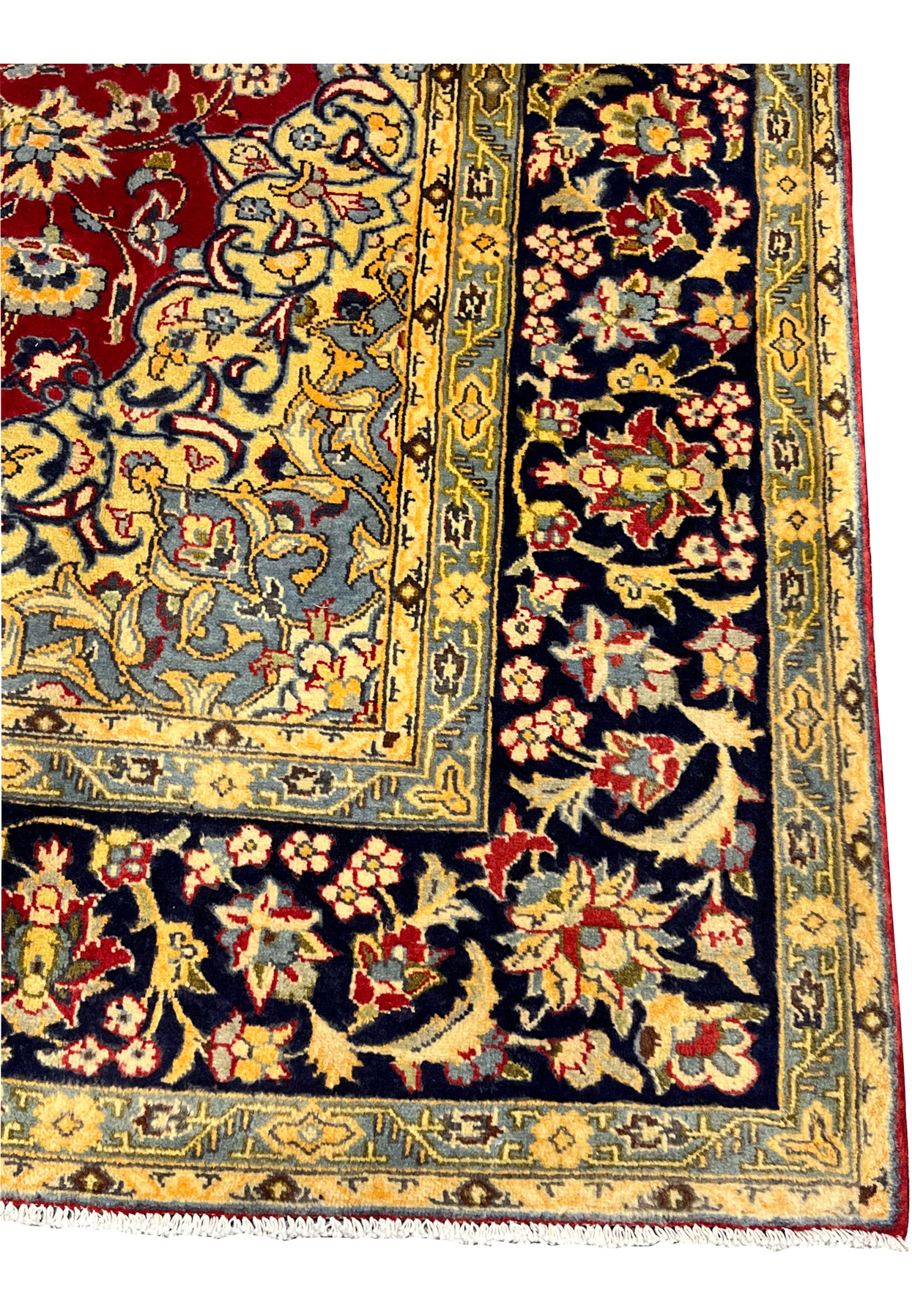Close-up of the navy main border populated with palmettes lotus blossoms and the slow curl of classical Persian vine scroll