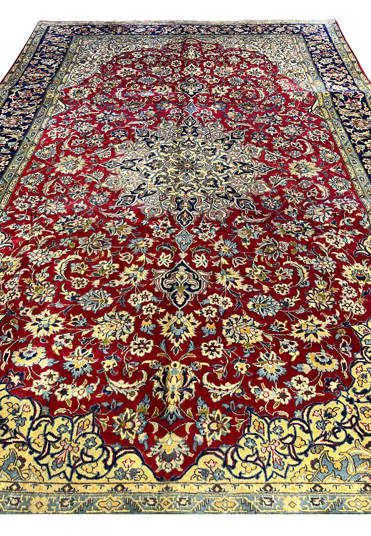 Top half detail of the Isfahan showing ivory medallion vine scrolls palmettes and the upper border procession of florals