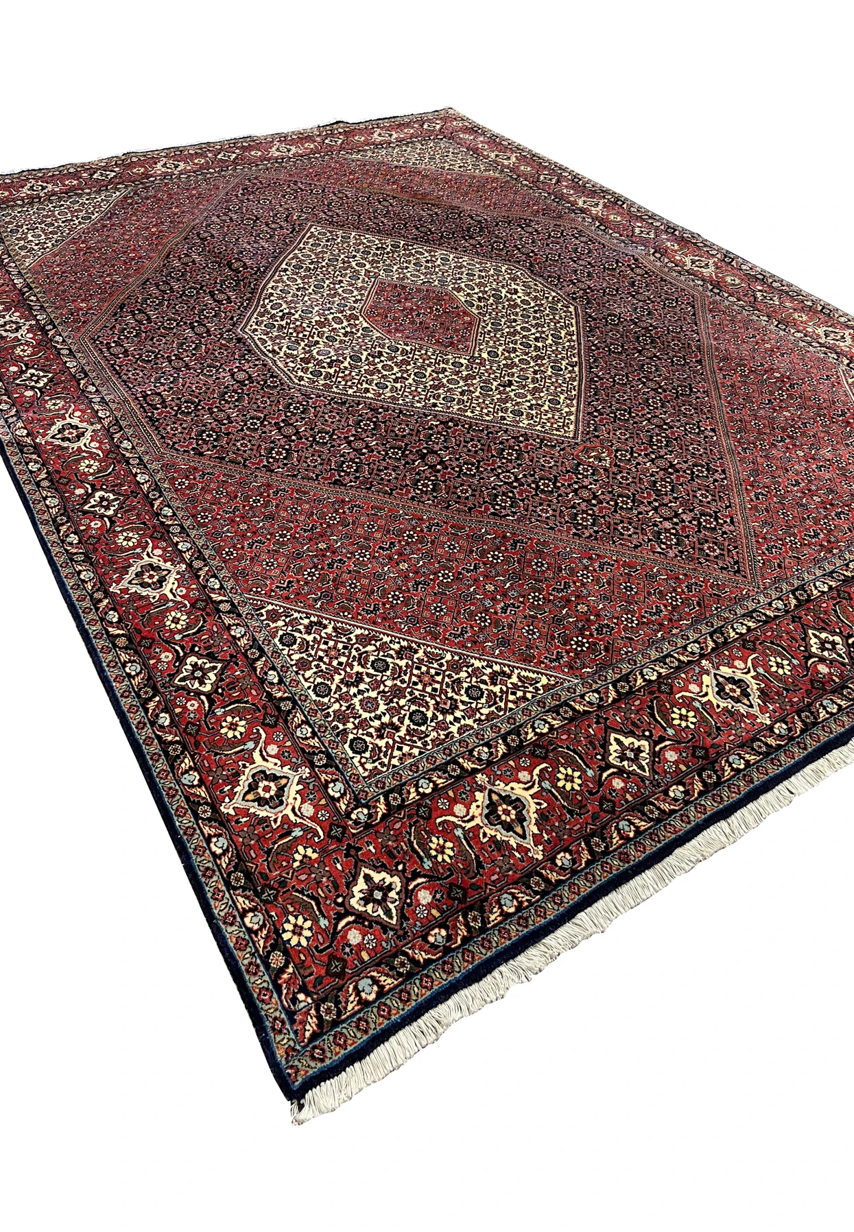 Angled three-quarter perspective of the Persian Bijar revealing scale, depth of color, and the dense herati infill across the field