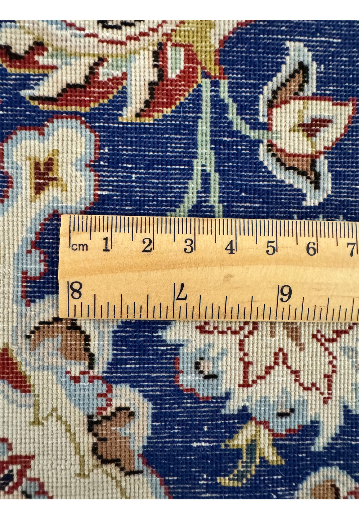 Tape measure across the back documenting the ultra fine knot density that places this Isfahan in the 550 to 600 KPSI master workshop range