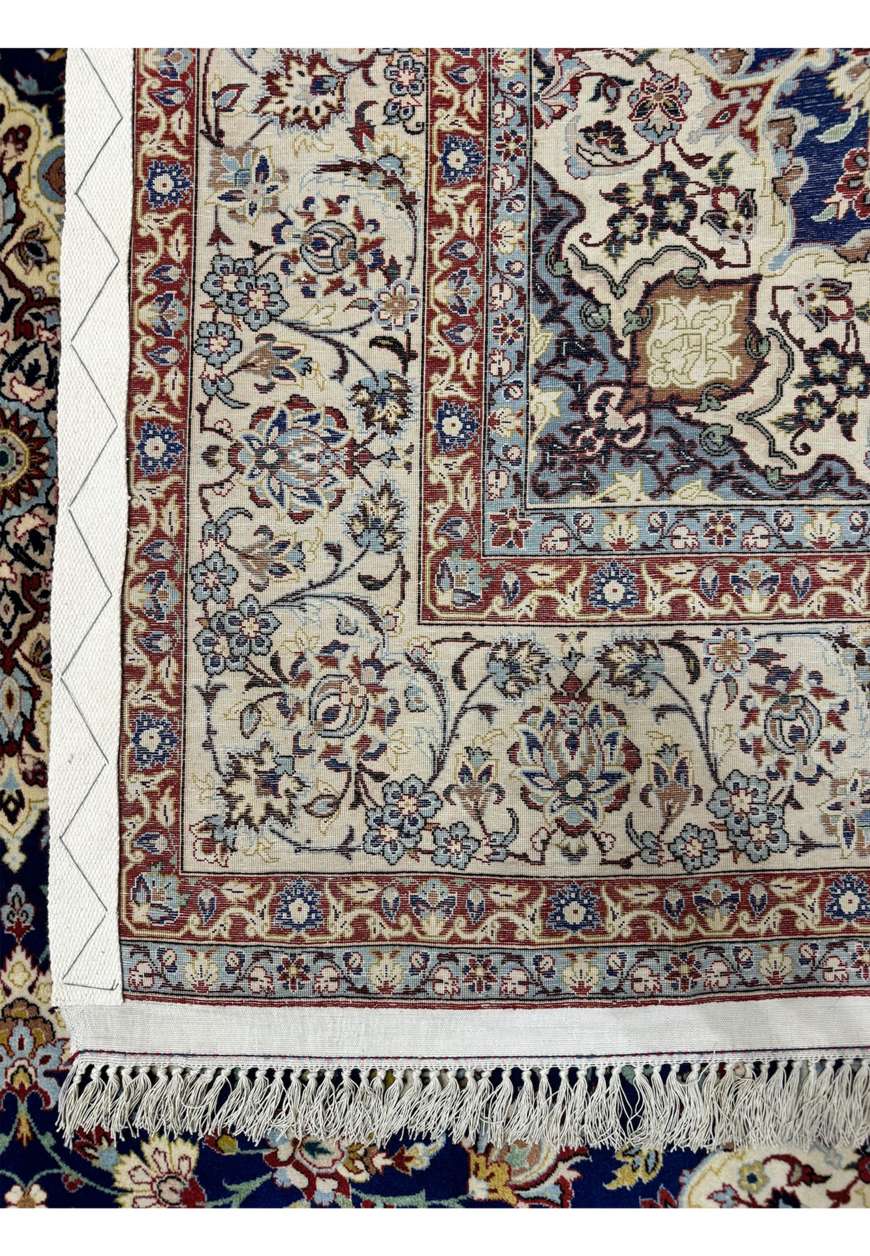 Backside fold revealing the dense knot structure and the clarity of the front pattern from the reverse, hallmark of a fine workshop Isfahan
