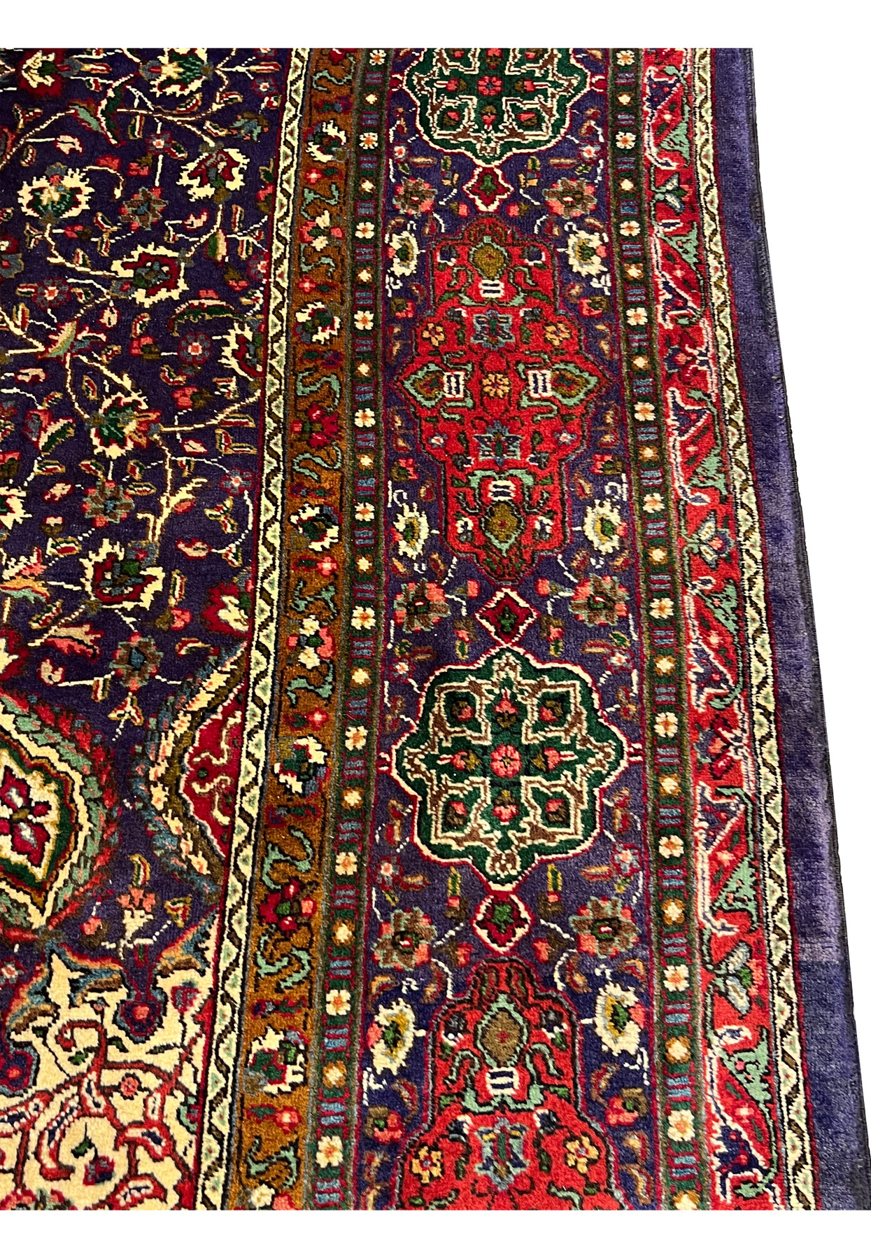 Border closeup of authentic Persian Tabriz rug with alternating green diamond and red shield cartouches
