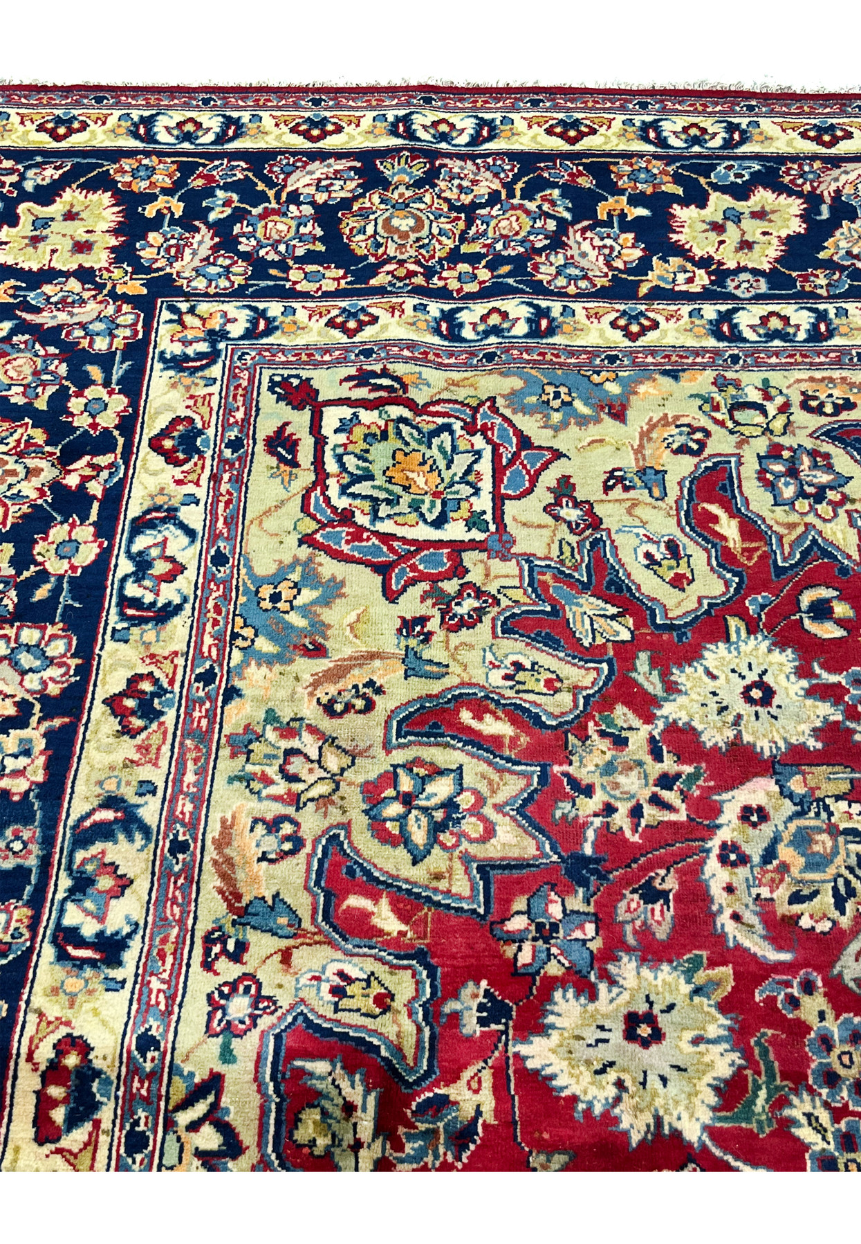 Inner border detail of Persian Isfahan rug showing scrolling vine and rosette palmettes on navy ground