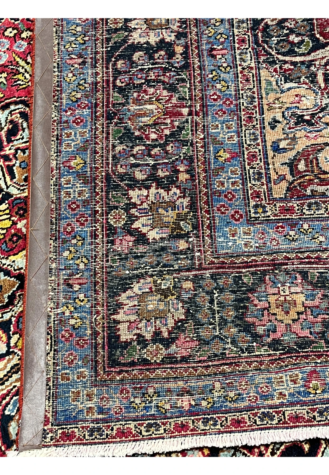 Backside of authentic Persian Kerman rug showing hand-knotted construction, tight weave structure, and natural ivory fringe